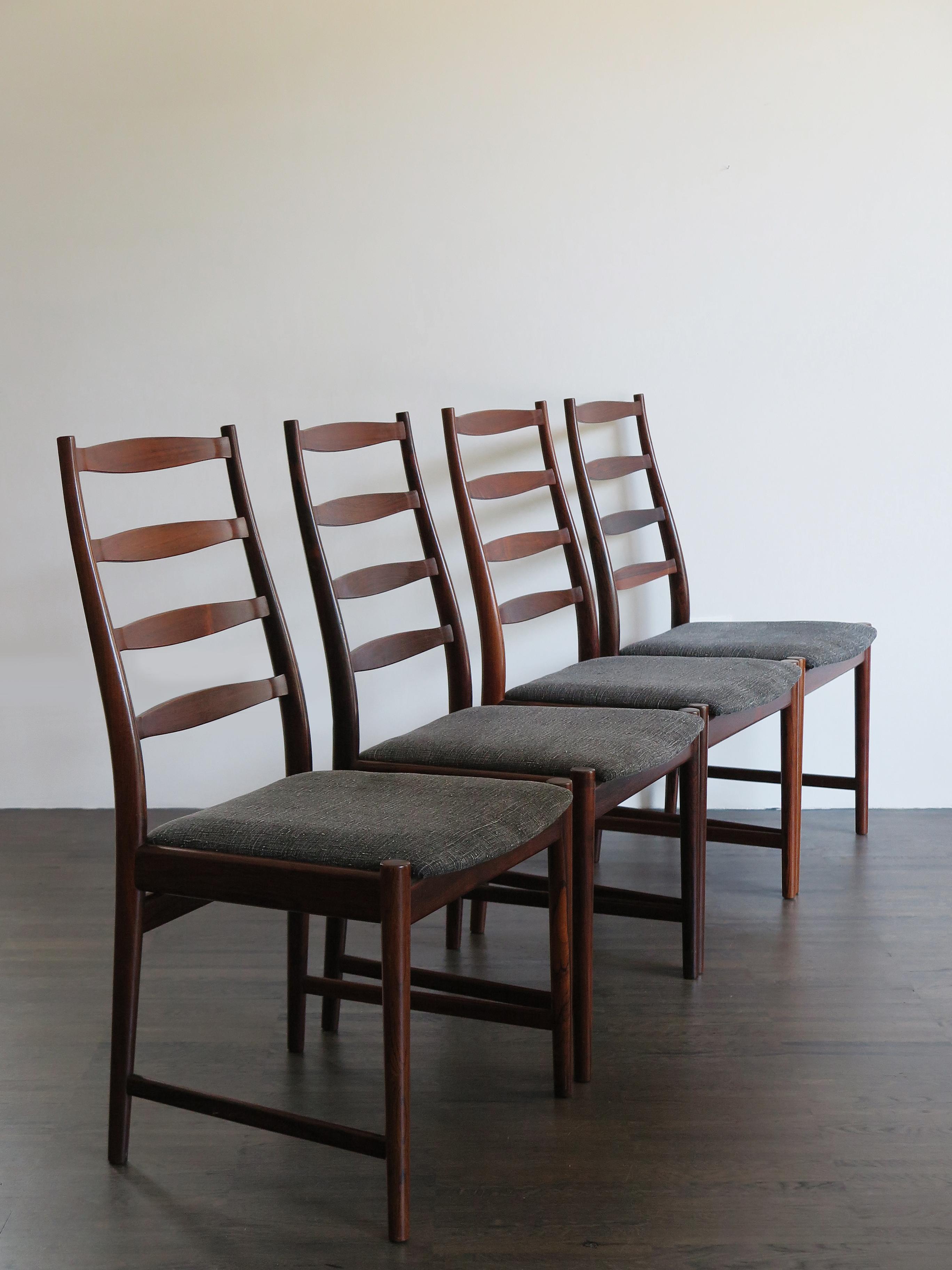 Set of four Scandinavian solid dark wood dining chairs, designed by Arne Vodder, manufacturer’s logo printed on the bottom and new lining fabric, Denmark 1960s

Please note that the chairs are original of the period and this shows normal signs of