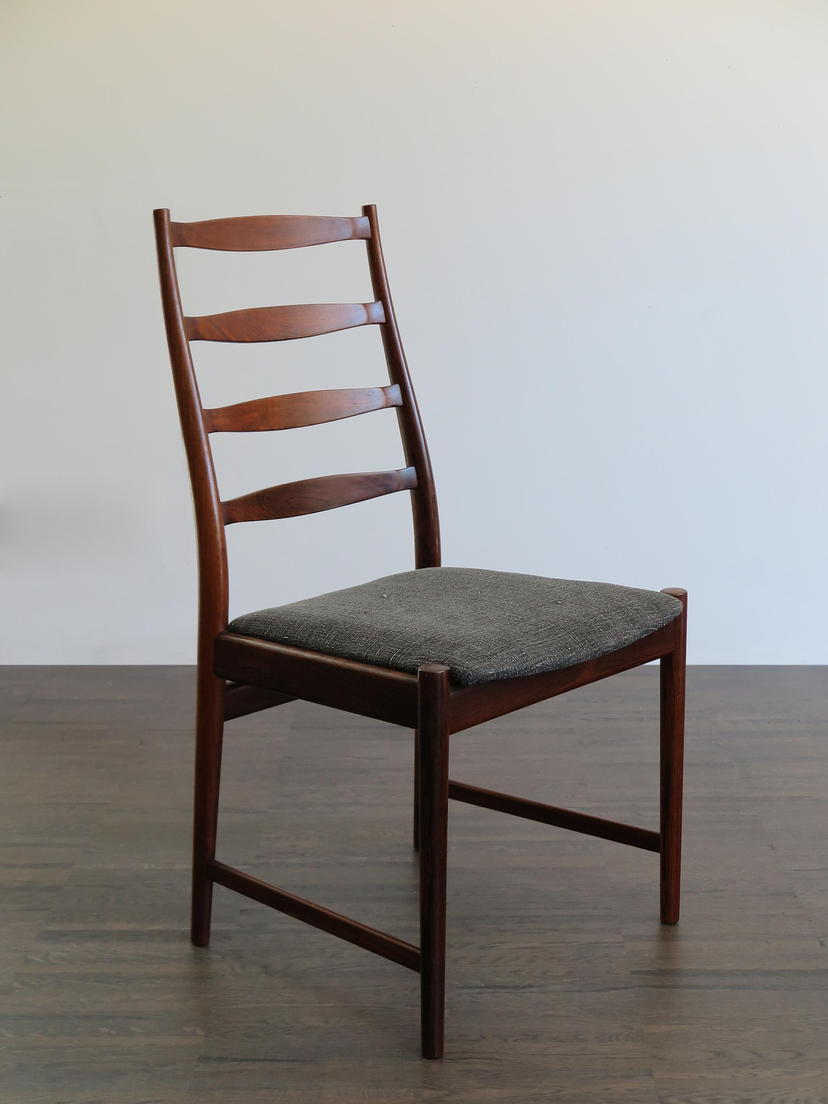 Set of two Scandinavian solid dark wood dining chairs, designed by Arne Vodder, manufacturer’s logo printed on the bottom and new lining fabric, Denmark 1960s

Please note that the chairs are original of the period and this shows normal signs of age