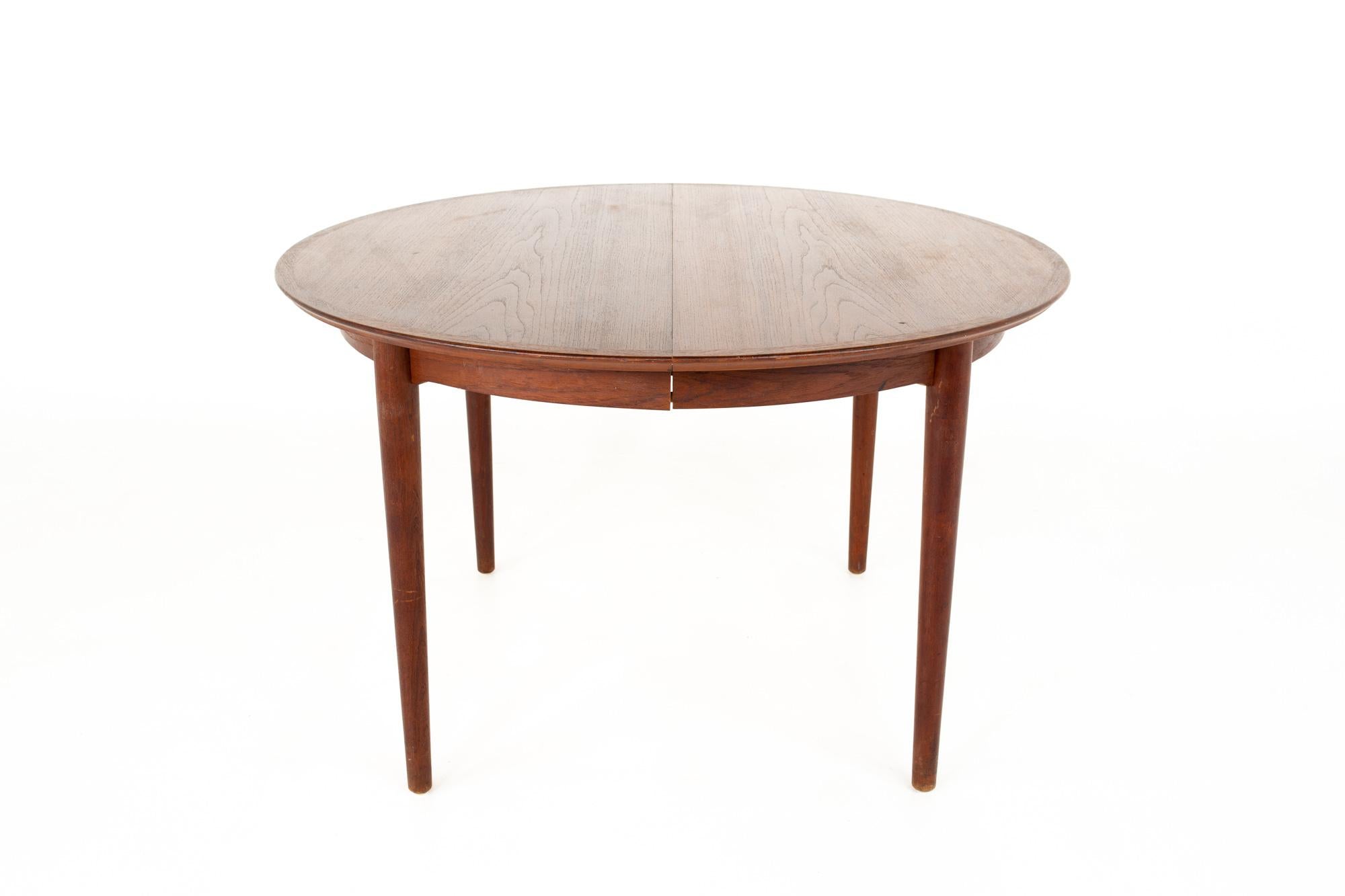 Arne Vodder Mid Century teak dining table

Table measures: 47.25 wide x 47.25 deep x 26 high 
Leaf measures: 19.75 inches wide 

This piece is available in what we call restored vintage condition. Upon purchase it is fixed so it’s free of