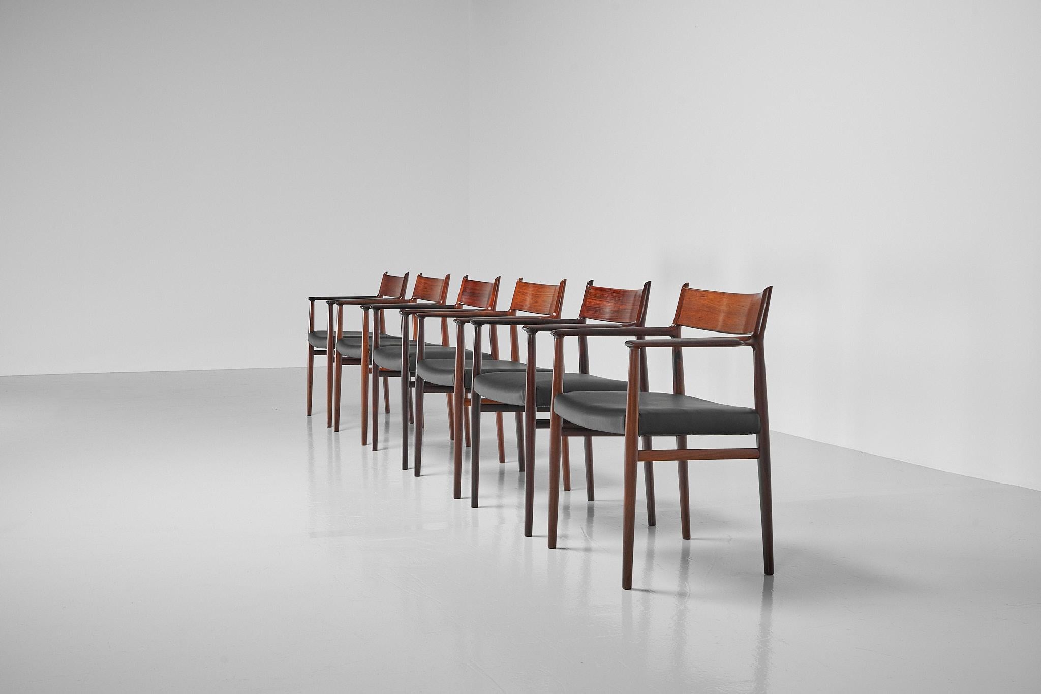 Superb set of 6 model 418b dining armchairs designed by Arne Vodder and manufactured by Sibast Mobler, Denmark 1960. These sleek chairs have solid rosewood frames which are very elegantly sculpted. The curved backrest is where the beautiful rosewood