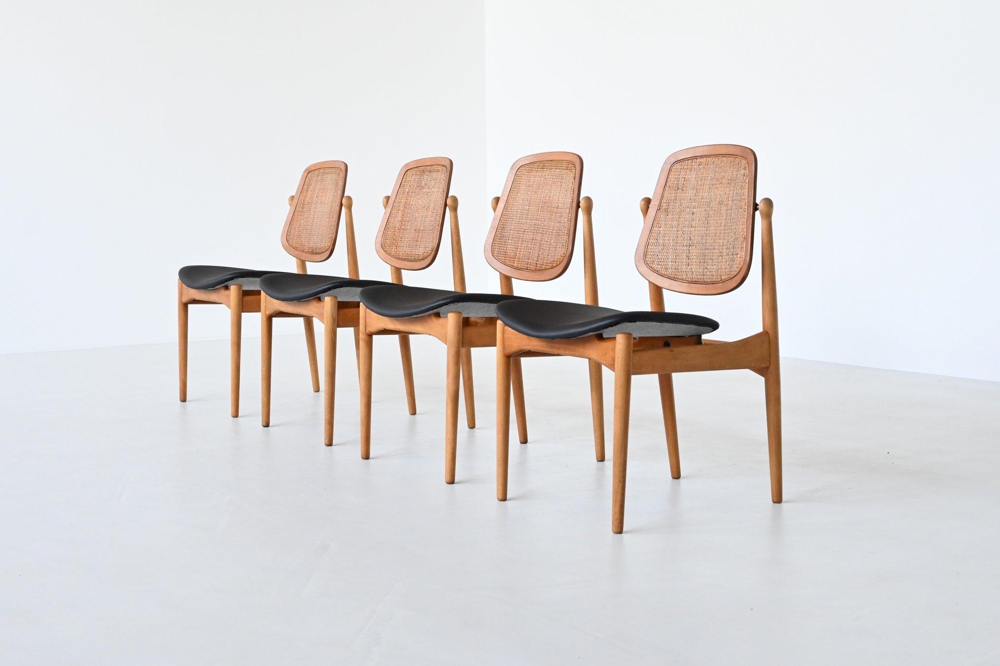Rare and incredible set of four dining chairs model FD-184 designed by Arne Vodder for France & Daverkosen, Denmark 1957. These dining chairs have a base made of solid birch wood and the seat is newly upholstered in high quality black leather which