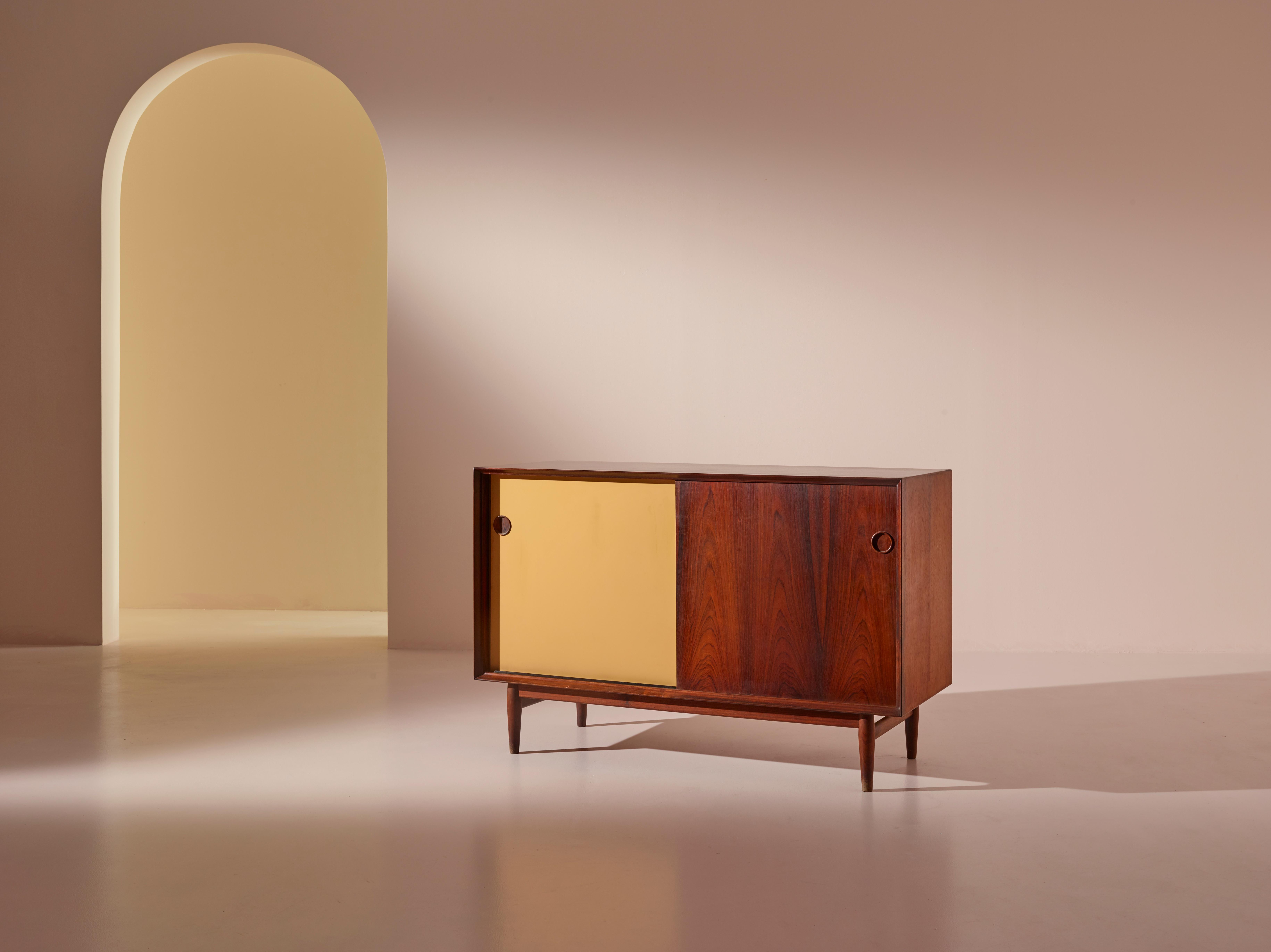 The Arne Vodder-designed sideboard, known as the OS11 and produced in Denmark by Sibast Mobler in the 1950s, is a beautiful and iconic piece of mid-century modern furniture. This sideboard is constructed from solid wood and features a rosewood