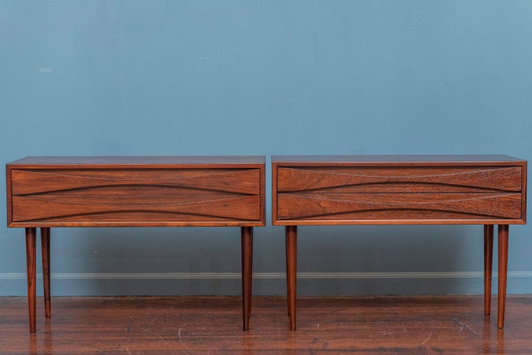 Arne Vodder design rosewood nightstands for N.C. Mobler, Denmark. Sophisticated design by a Danish design master executed in Brazilian rosewood with his signature drawer pull design. Rare pair of nightstands that have just been newly refinished and
