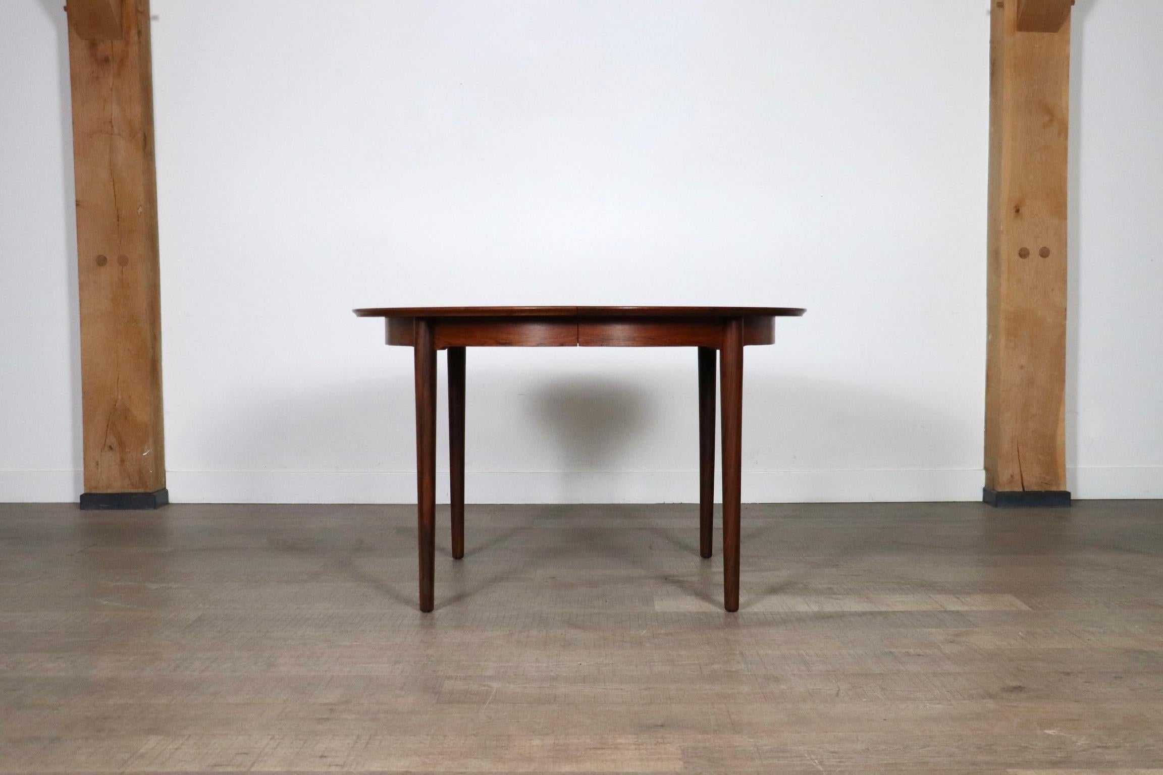 Fantastic round to oval model 204 extendable dining table designed by Arne Vodder for Sibast Mobler, Denmark 1955.

This clever minimalistic design comes with 2 extension leaves. This means the table will extend from 120 cm diameter round, to 170 cm