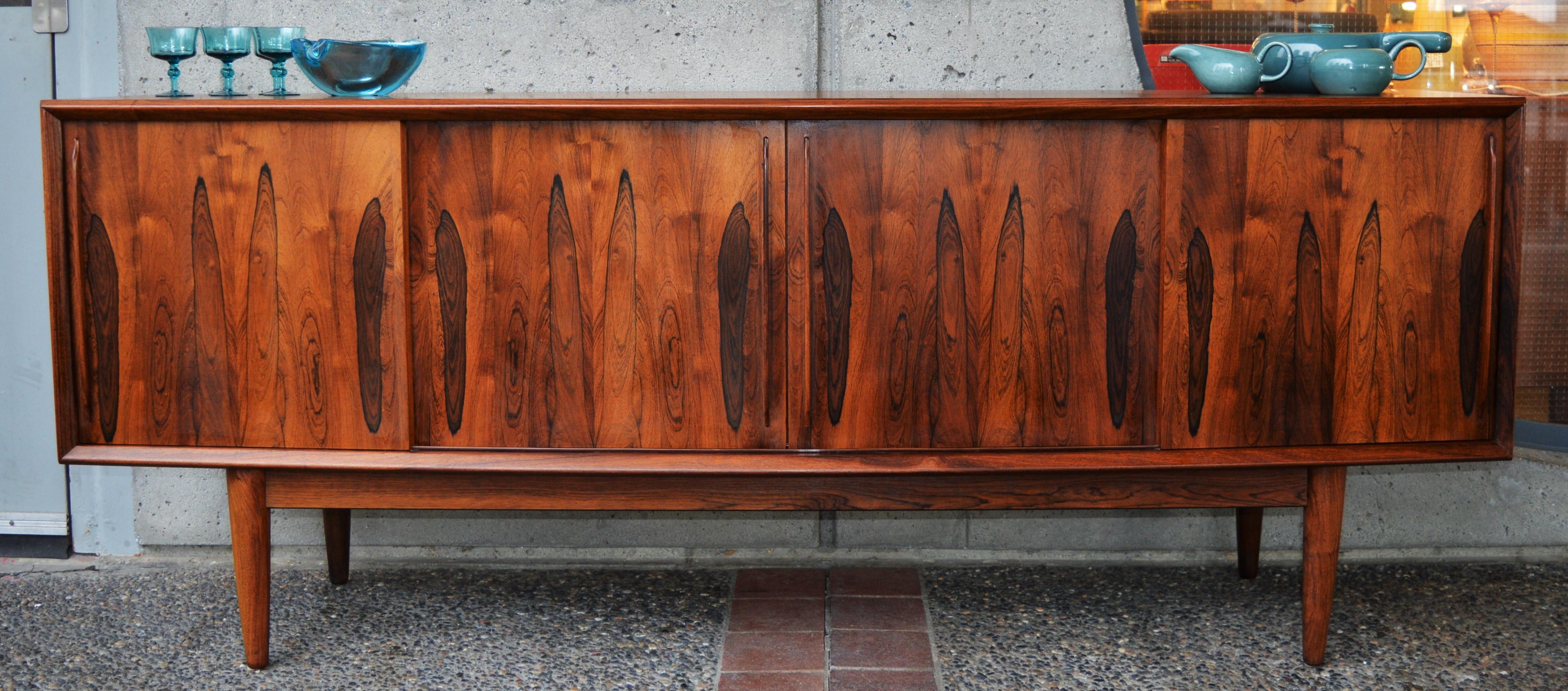 This stunning Danish modern rosewood credenza / buffet by Arne Vodder for H.P. Hansen has gorgeous, classical lines with it's beautiful arced bow-front. Internally, the components are teak, a wonderful contrast to the rosewood with two adjustable