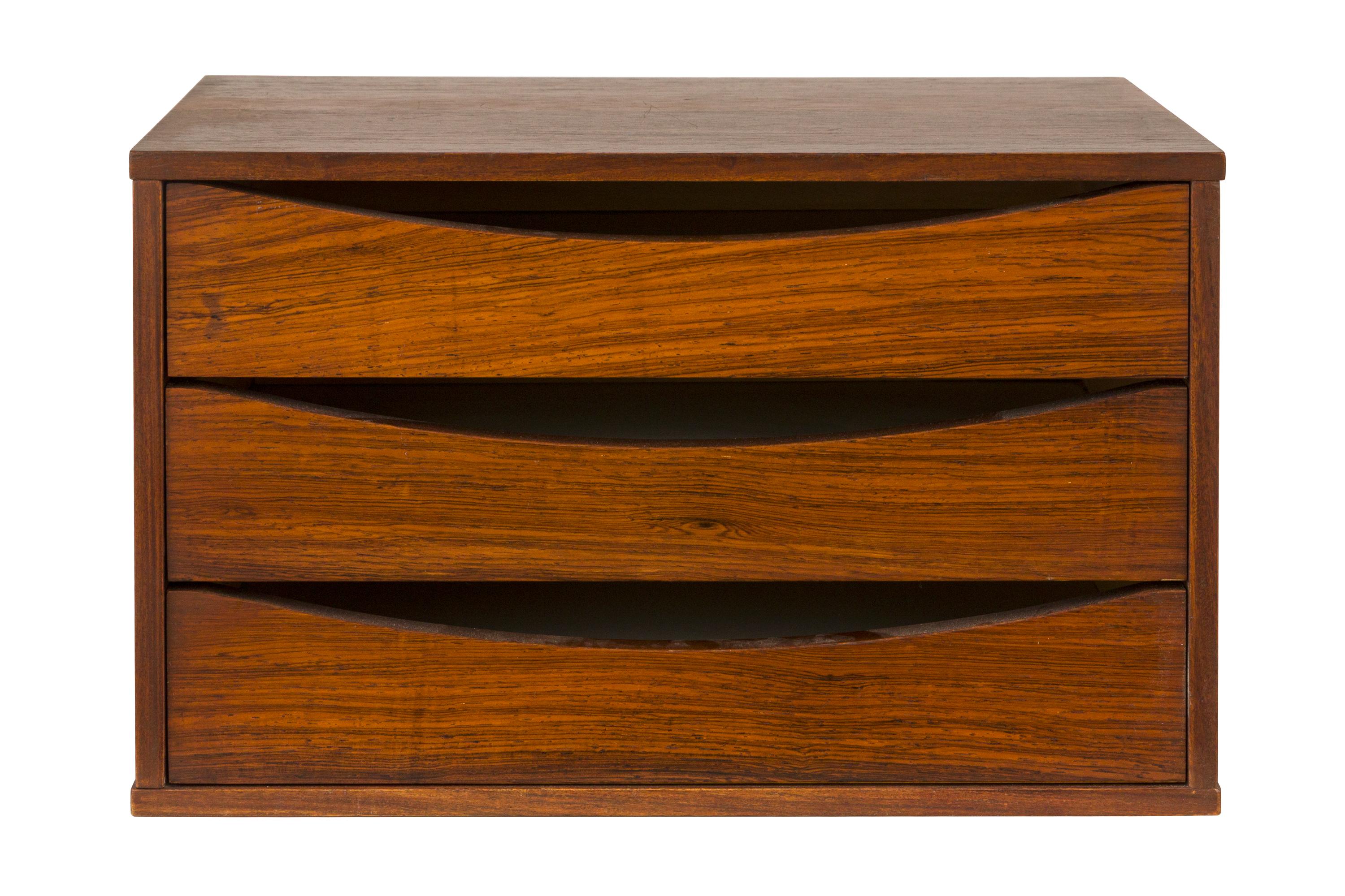 A practical and attractive small chest of drawers that could be used for a variety of purposes. Usually found in teak, this is an outstanding rosewood version.