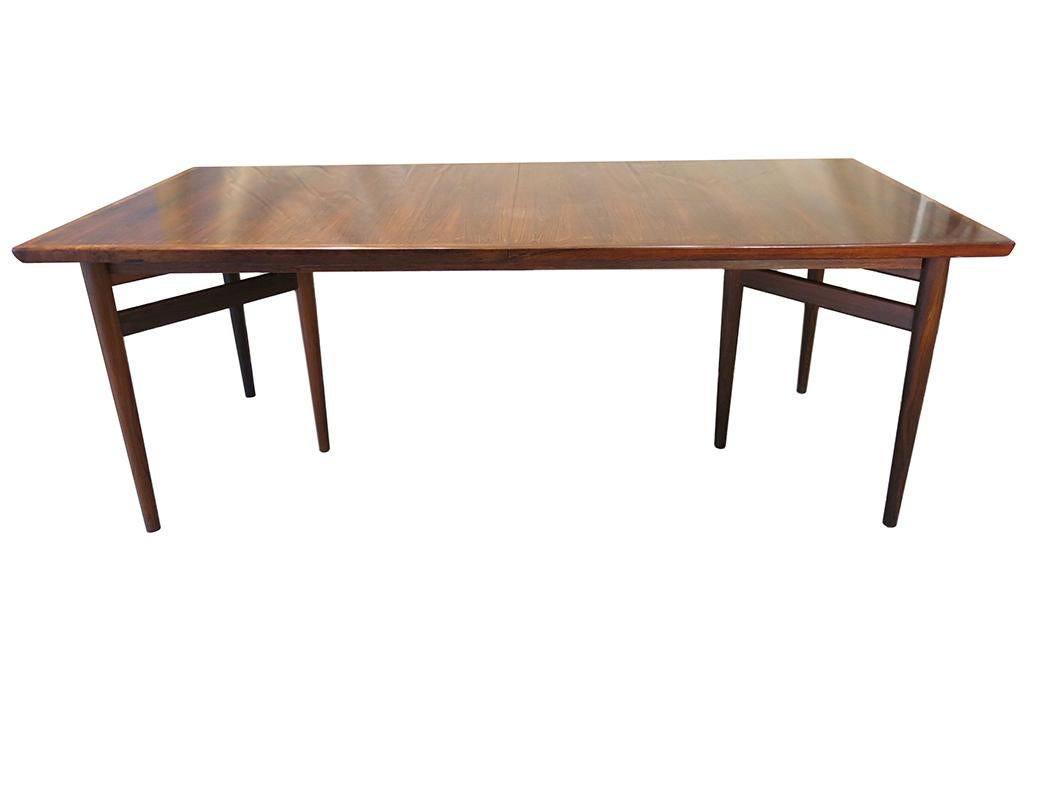 This dining table was created by Danish furniture designer, Arne Vodder (1926 - 2009). Vodder studied under the iconic designer, Finn Juhl, and later became his business partner. In 1951 Vodder opened his own design studio with Anton Borg. Together