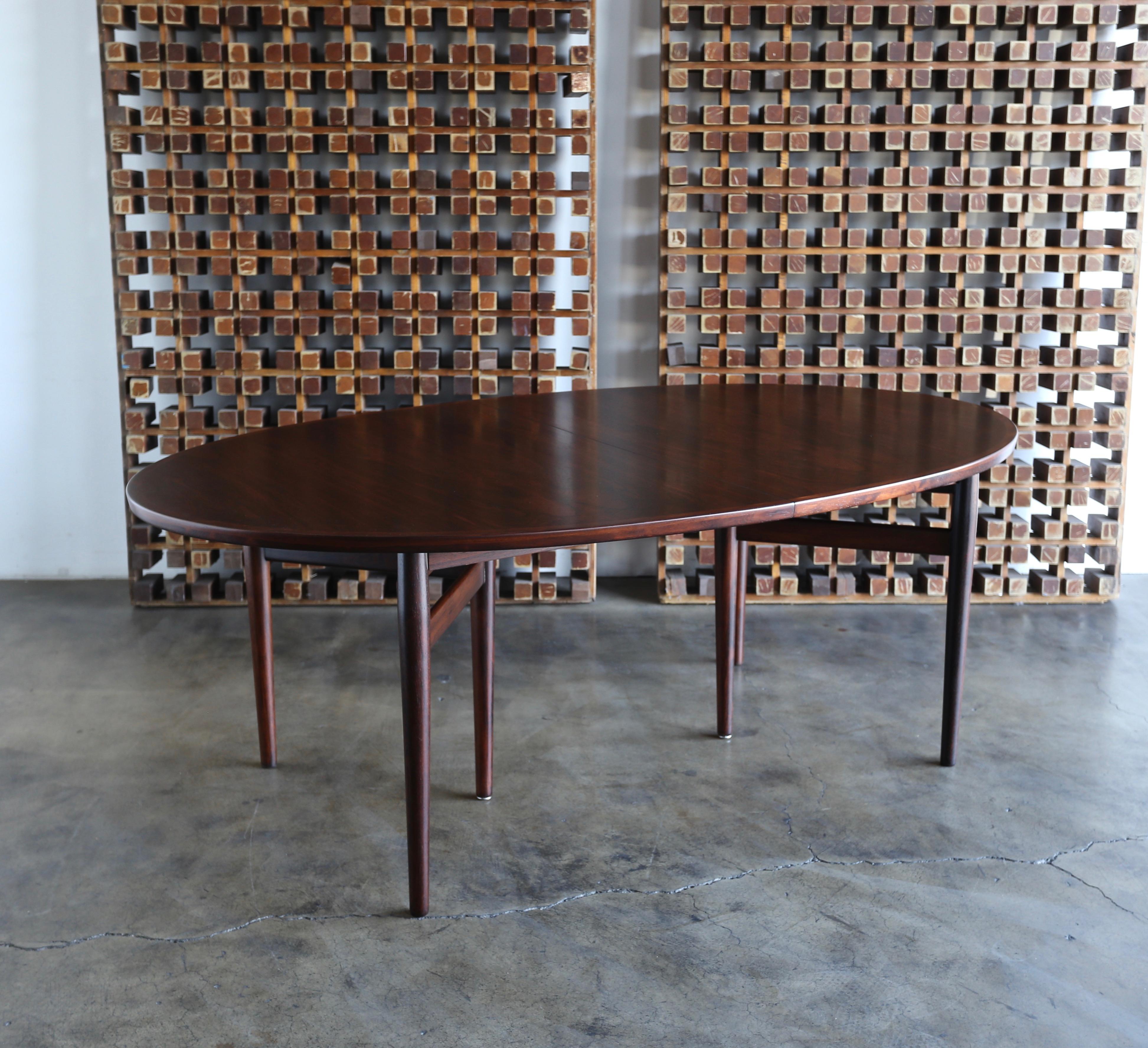 Arne Vodder rosewood dining table for Sibast, circa 1960. Dynamic rosewood grain. This piece has been professionally restored. 

This table extends to: 117