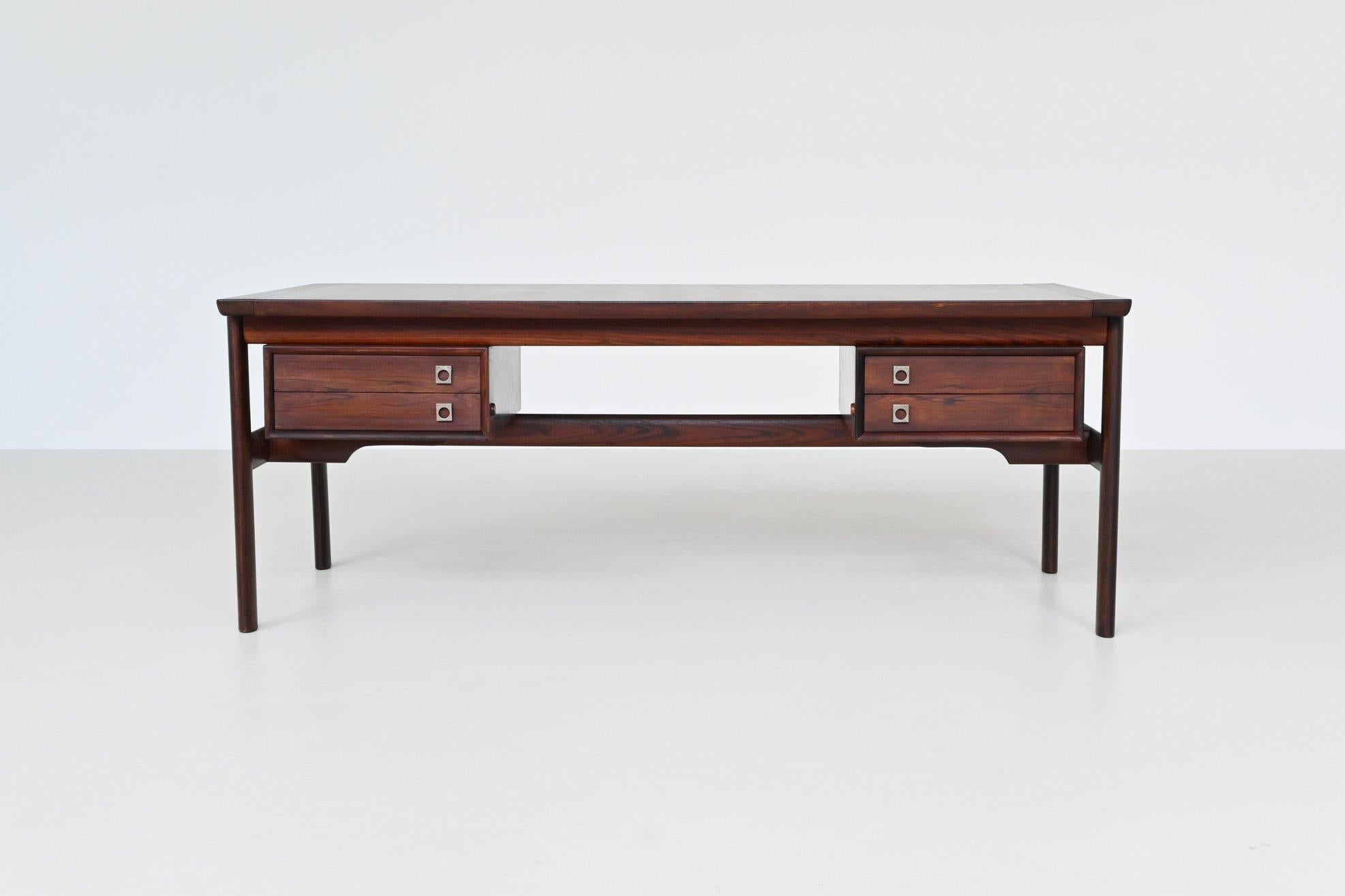 Iconic executive desk from the “200 series” designed by Arne Vodder; one of the best designers Denmark has known and it is manufactured by Sibast Furniture, Denmark 1960. This luxurious desk features a lot of storage space and shows wonderful