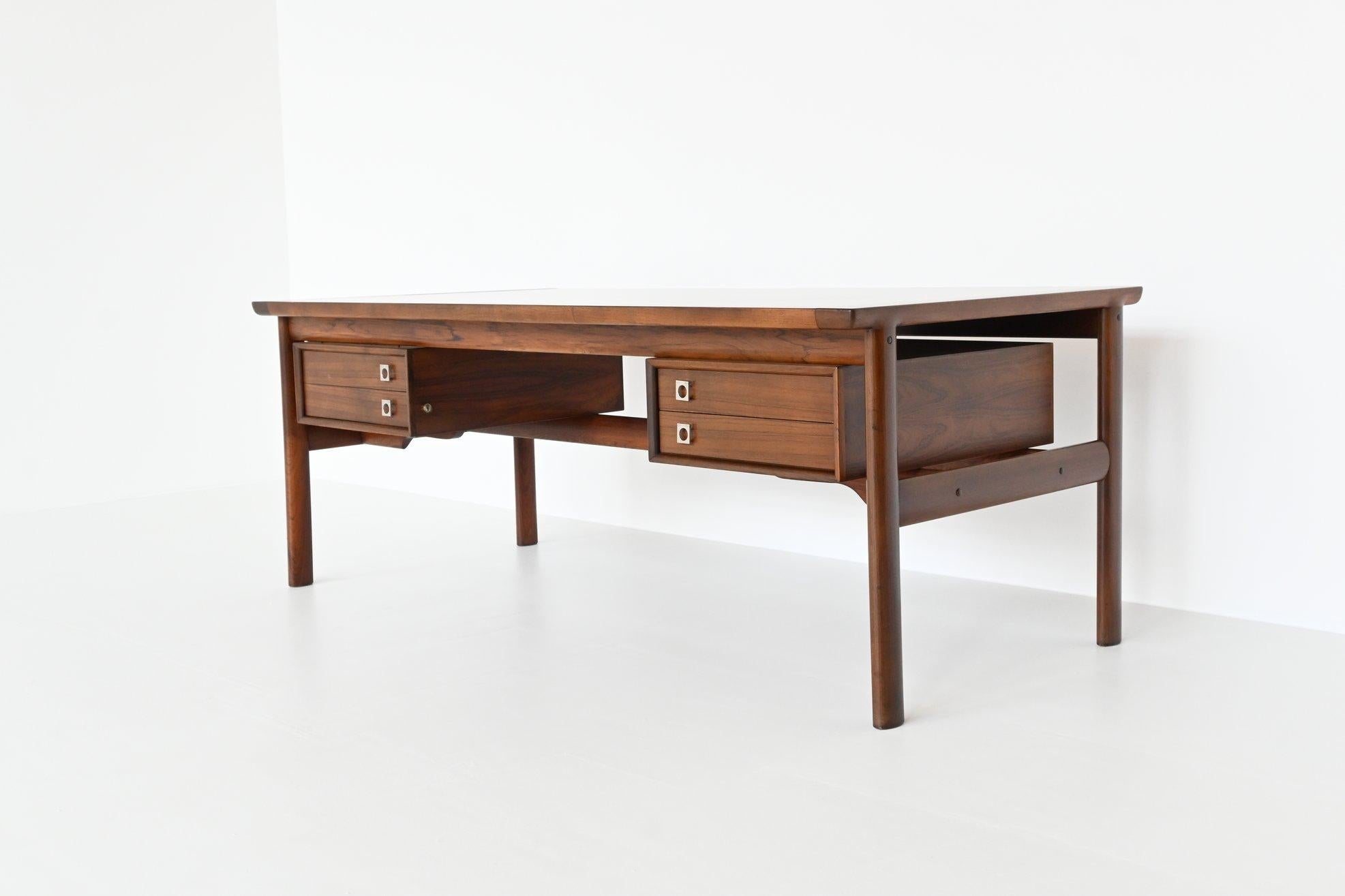Iconic executive desk from the “200 series” designed by Arne Vodder; one of the best designers Denmark has known and it is manufactured by Sibast Furniture, Denmark 1960. This luxurious desk features a lot of storage space and shows wonderful