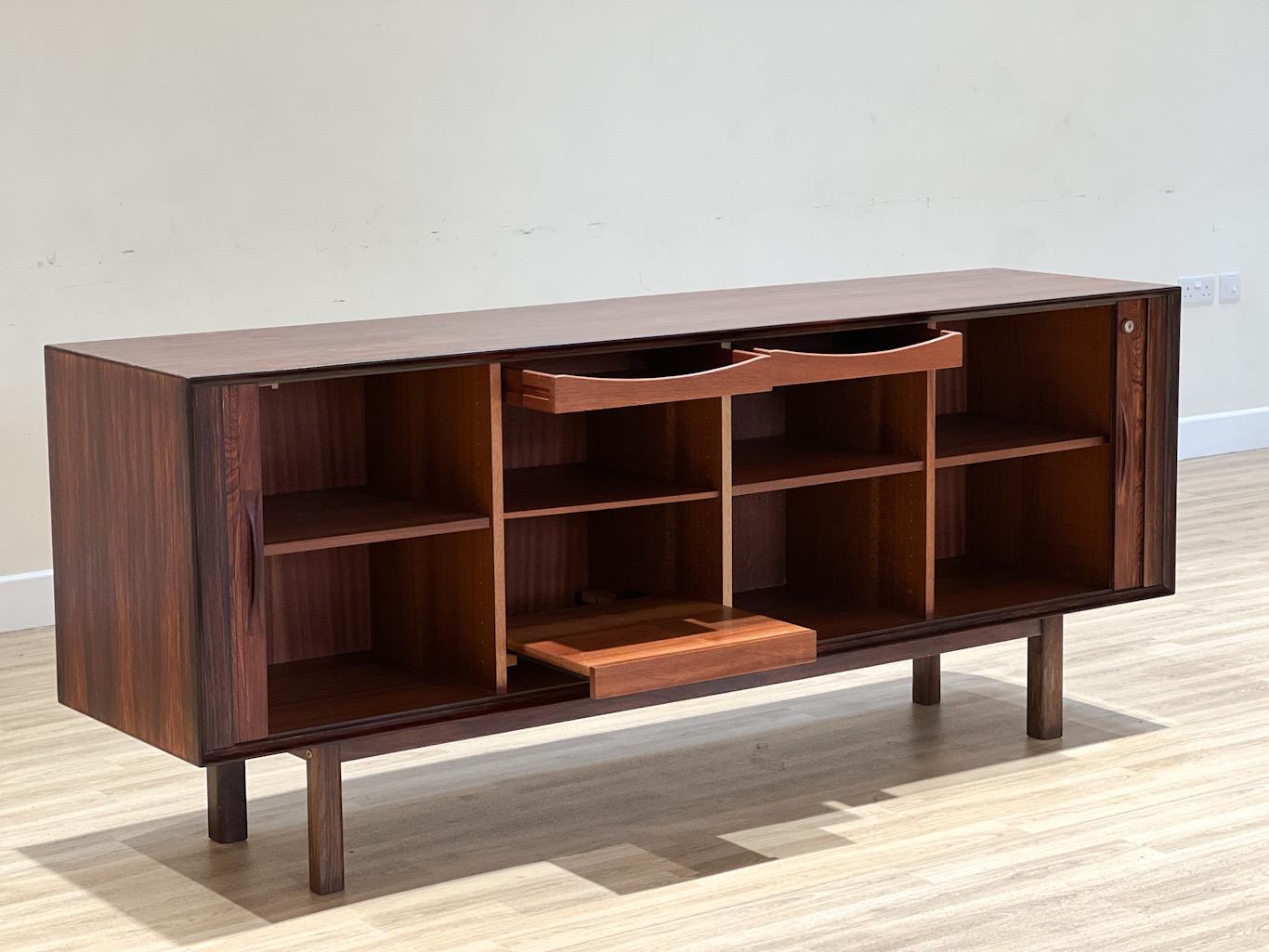 This stunning sideboard was created by the famous designer Arne Vodder and meticulously handcrafted in rosewood by the renowned Danish cabinetmaker Sibast in the 1960s. It is a testament to the exceptional craftsmanship and design of its era. 

One