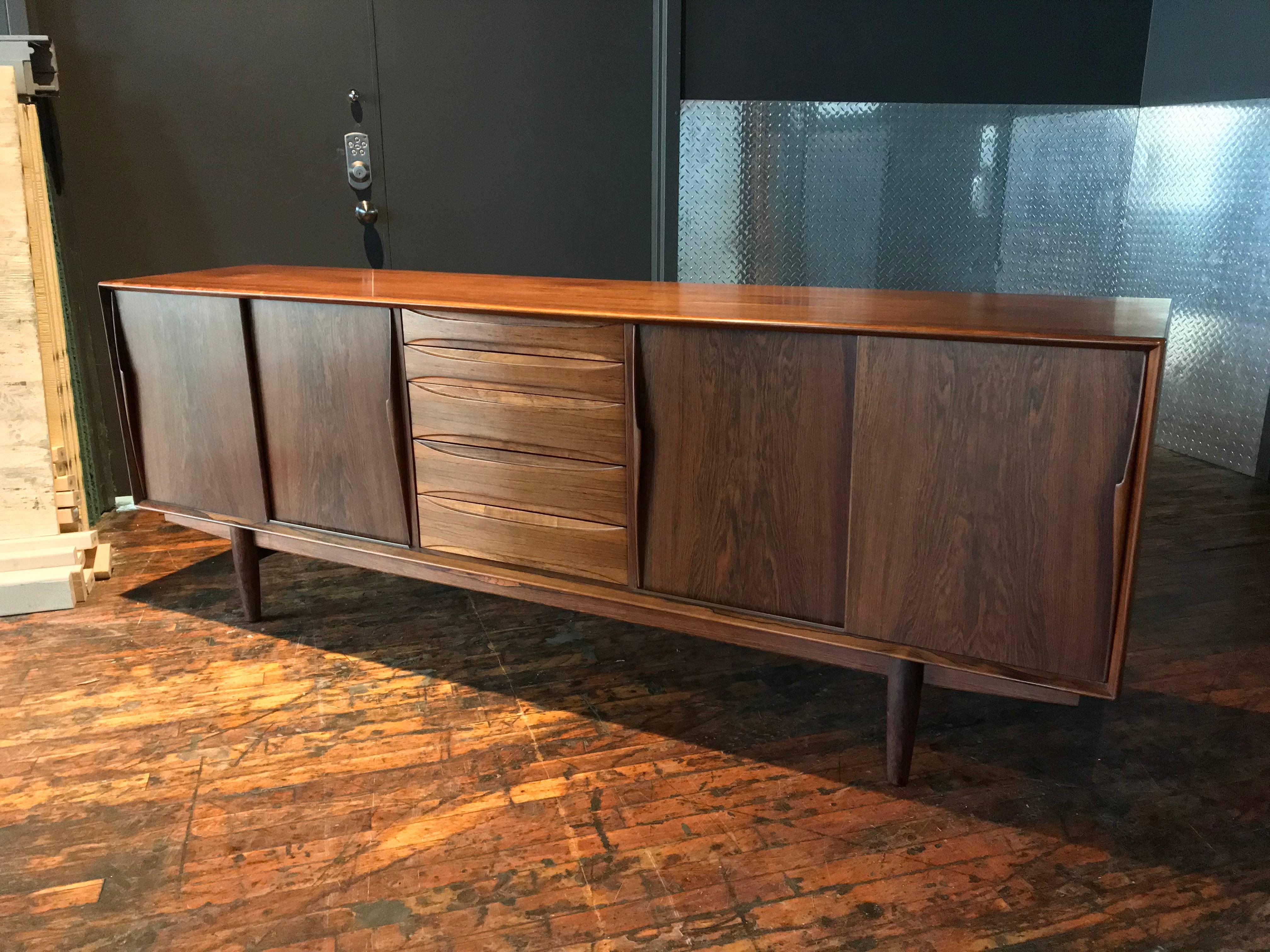 Arne Vodder rosewood sideboard fitted with two sliding doors hiding shelves and five drawers in the middle.