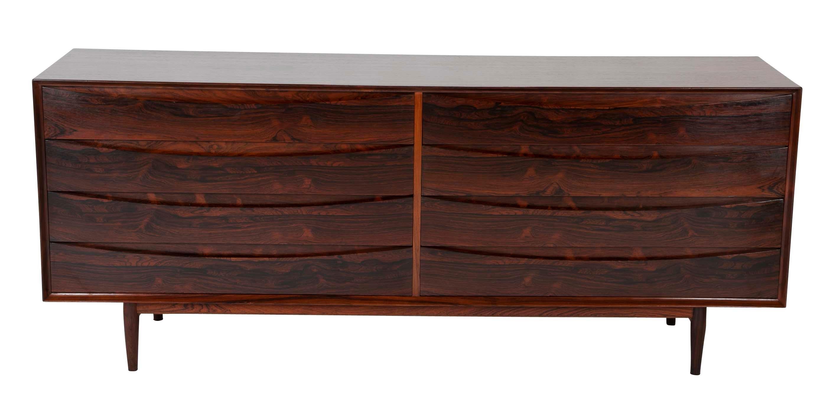 A Danish eight-drawer chest with elliptical shaped drawers pulls. Executed in Brazilian Rosewood. Designed by Arne Vodder for Sibast Mobler, Danish, circa 1950. Marked in drawer.