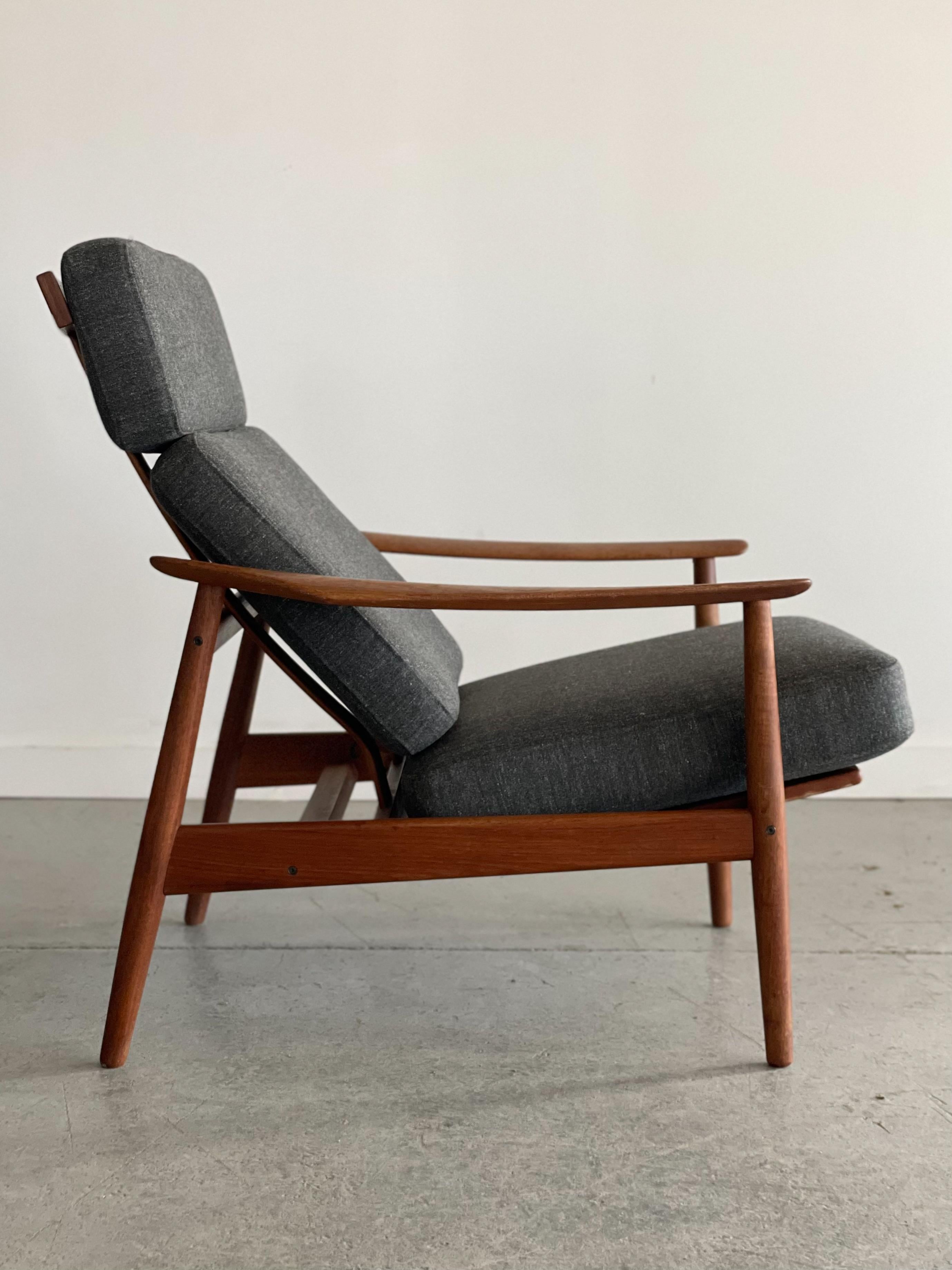 Stunning model FD164 teak recliner designed by Arne Vodder in 1962 for France & Son, Denmark. This piece features beautifully sculpted armrests, an open contoured backrest, and three-reclining positions. It has been redone in a high-quality wool