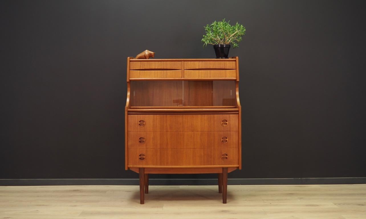 Phenomenal cabinet from the 1960s-1970s, a Minimalist form, designed by Arne Vodder. The surface of the furniture is covered with teak veneer. The furniture has seven drawers, a pull-out top and glass doors. Maintained in good condition (minor