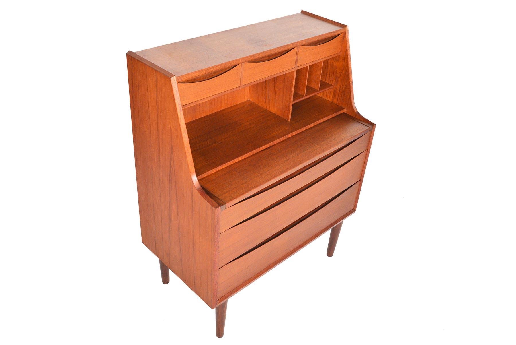 Designed by Arne Vodder in the 1960s, this Danish modern teak secretary is bursting with functionality! A secretary top is outfitted with three small drawers and divided storage. Top drawer pulls out to create a desk and when the top plate is