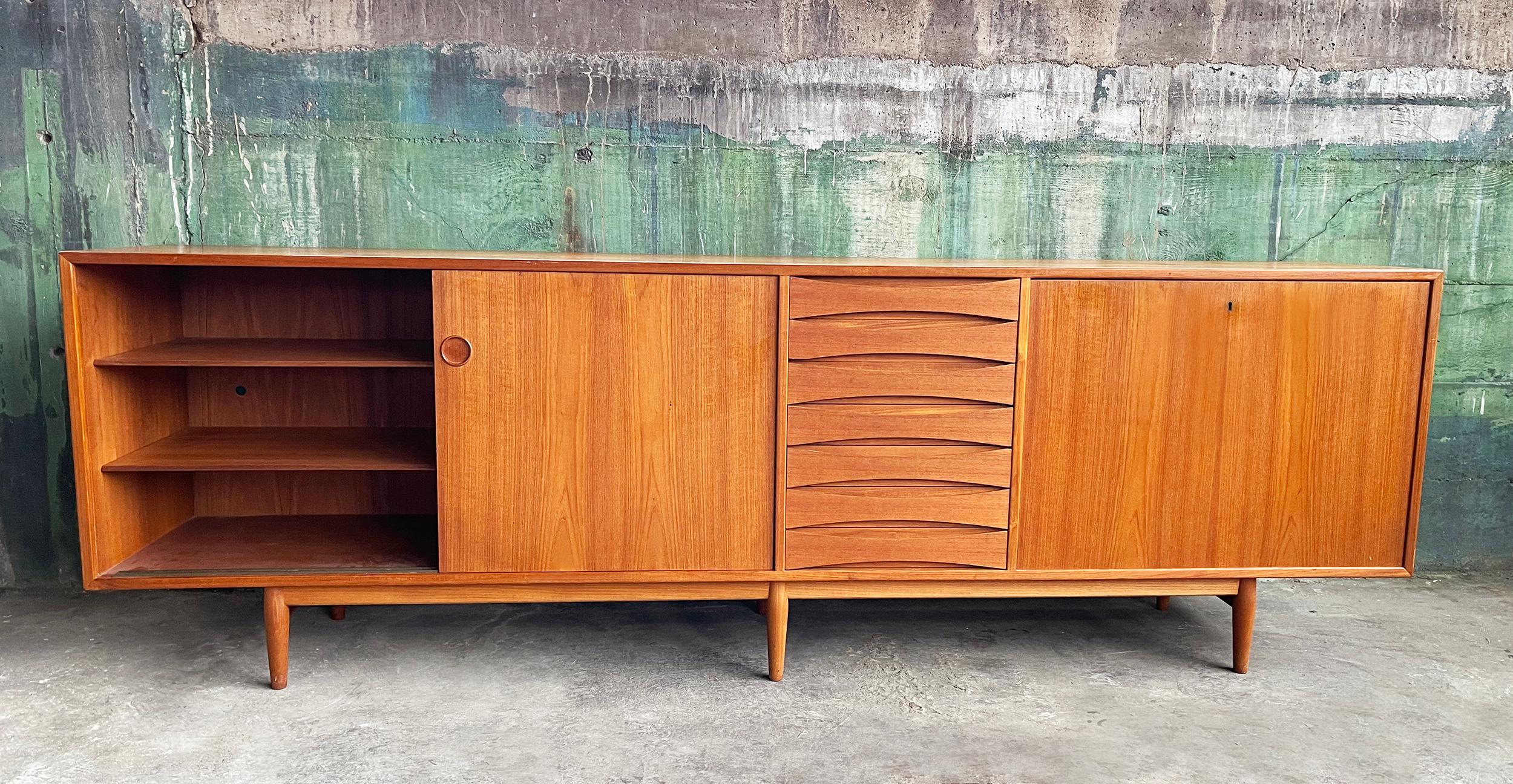 This Sibast Mobler's model 29A teak credenza designed by Arne Vodder during the 1950s is truly stunning, coveted and a rare designer piece to have the opportunity to collect. With a length of 8 feet, this piece boasts exceptional workmanship, sleek