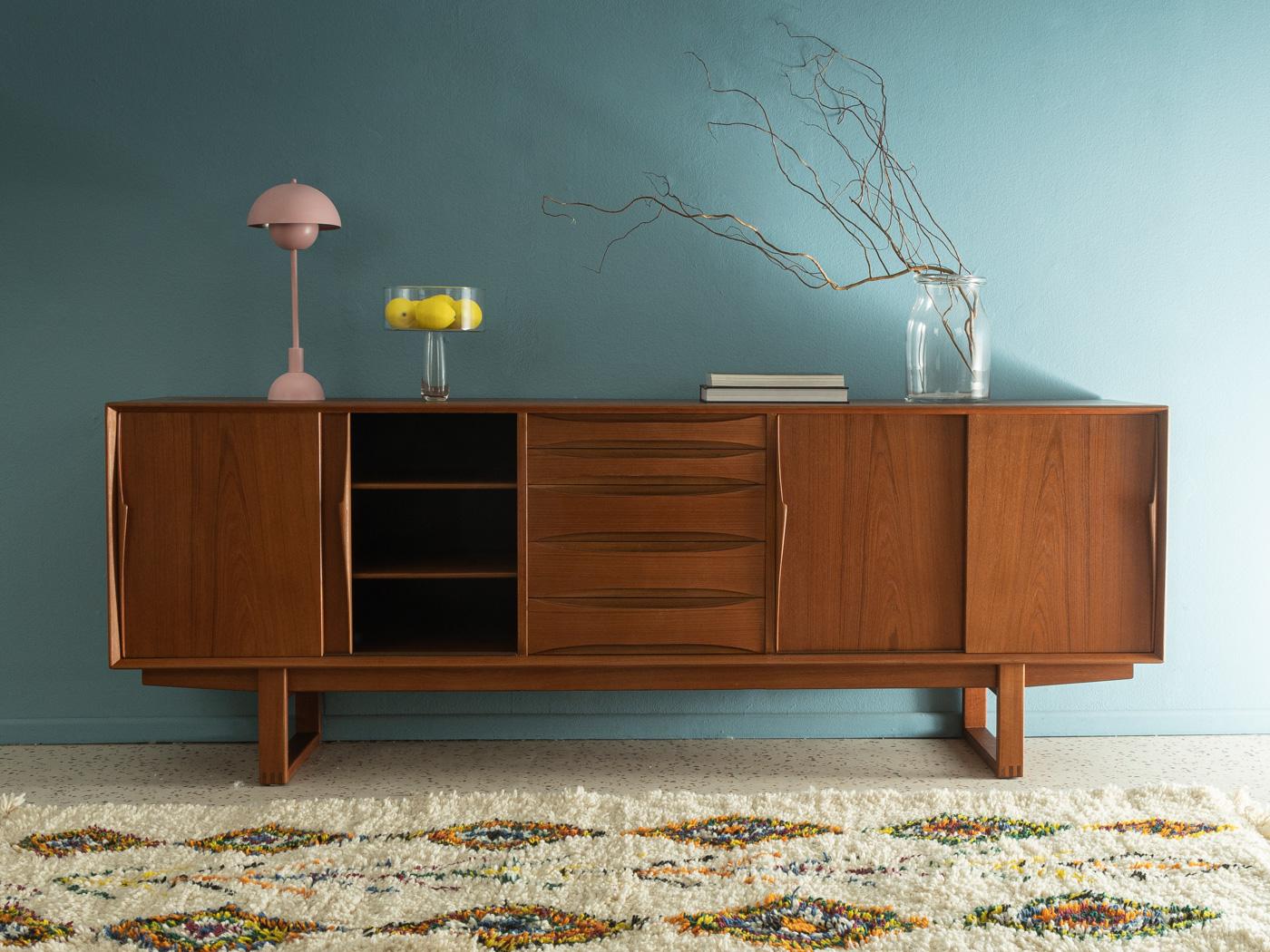 Classic sideboard from the 1960s by Arne Vodder for Skovby Møbelfabrik. High-quality corpus in teak veneer with four sliding doors, two shelves, five drawers and solid wood frame.

Quality Features:
 accomplished design: perfect proportions and