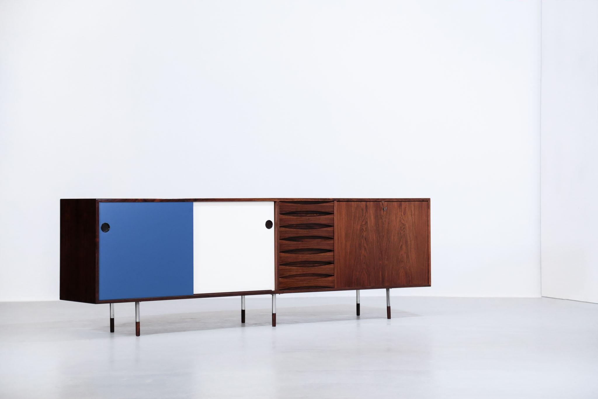 Rare Danish sideboard designed by Arne Vodder for Sibast in 1958.
Made of rosewood, the sideboard is composed of two sliding doors, seven drawers and one swing door.
Sliding doors are reversible.
