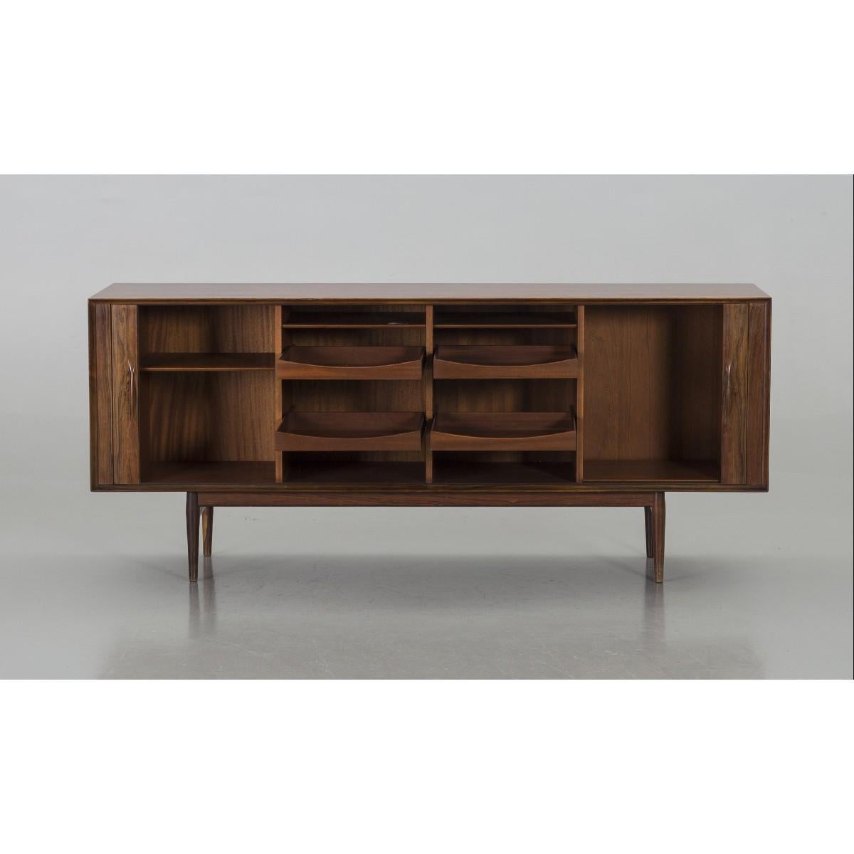 A sideboard of model 75 designed by the Danish designer Arne Vodder and produced at Sibast Møbelfabrik in Denmark. The sideboard was designed probably in the late 1950s-in the early 1960s. The sideboard is made in Brazilian rosewood and comes with a