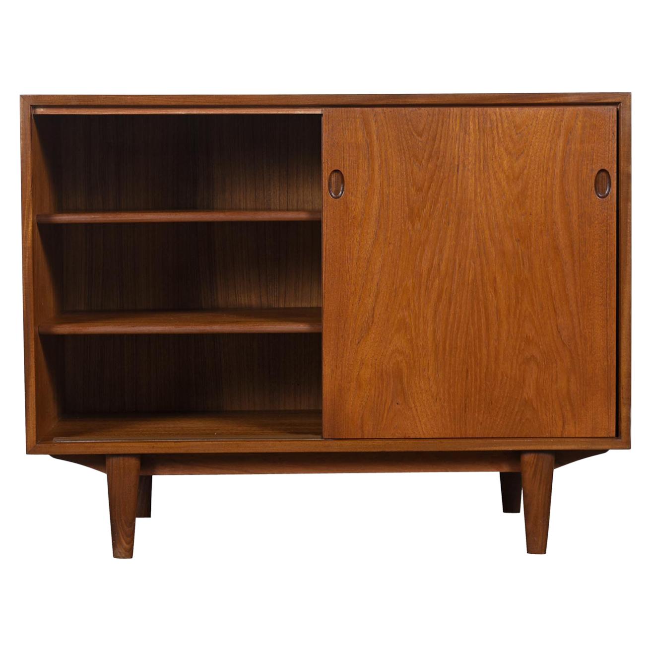 This cabinet looks exactly like other pieces designed by Arne Vodder, but it's unmarked. 

The size and proportions make this the ideal record cabinet. Large enough to display a turntable and receiver on top and tons of records inside. The deep,