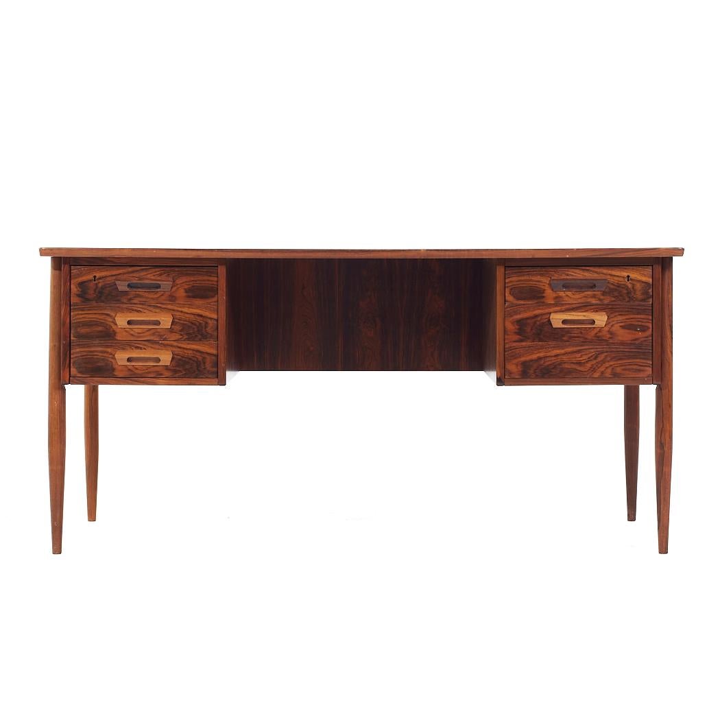 Arne Vodder Style Mid Century Danish Rosewood Desk

This desk measures: 59 wide x 28.5 deep x 28.5 high, with a chair clearance of 27.25 inches

All pieces of furniture can be had in what we call restored vintage condition. That means the piece is