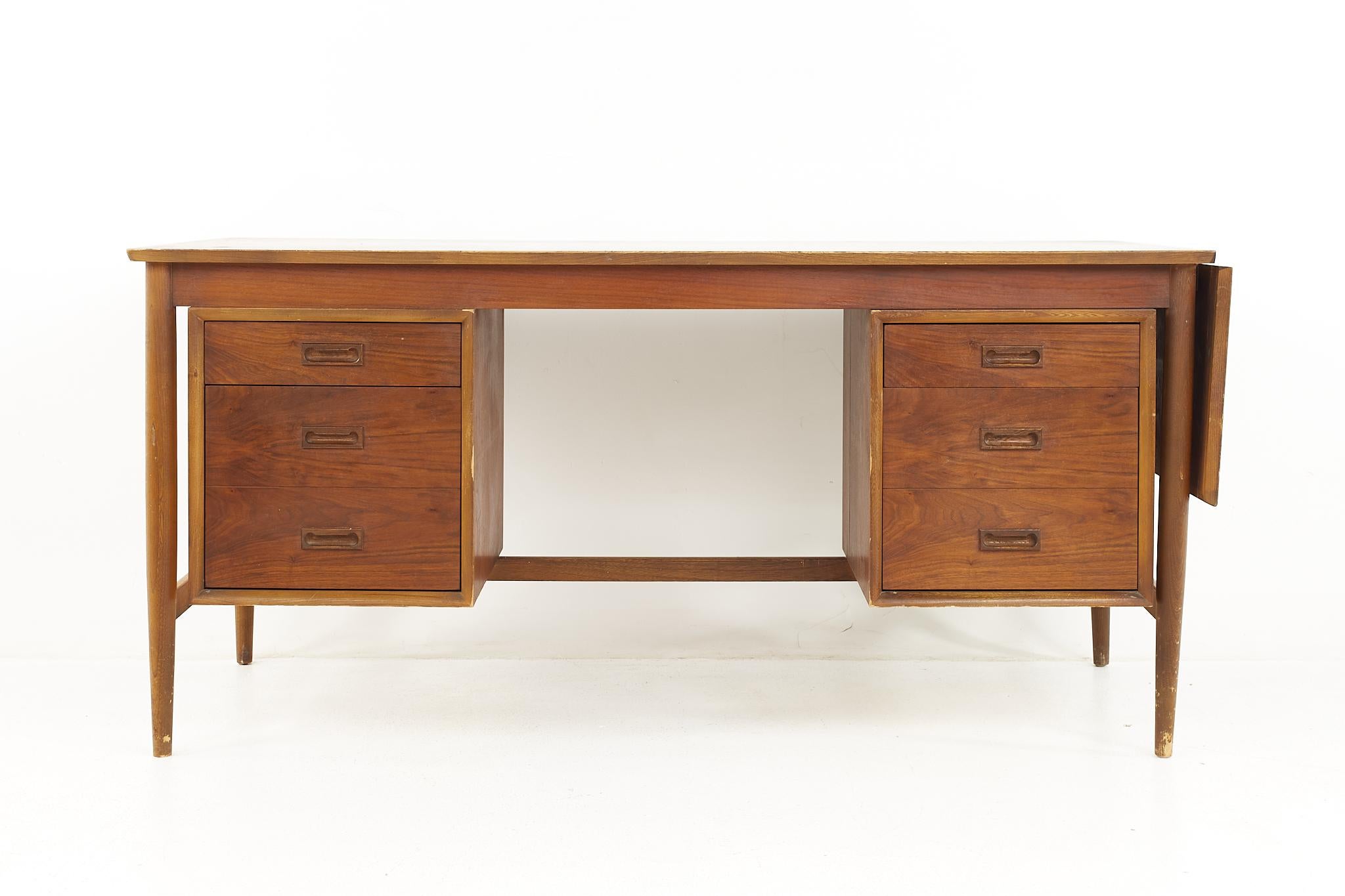 Arne Vodder style mid century Danish walnut desk

The desk measures: 61 wide x 27 deep x 29 high, with a chair clearance of 25.5 inches; when the leaf is used the desk measures 74.5 inches wide 

All pieces of furniture can be had in what we