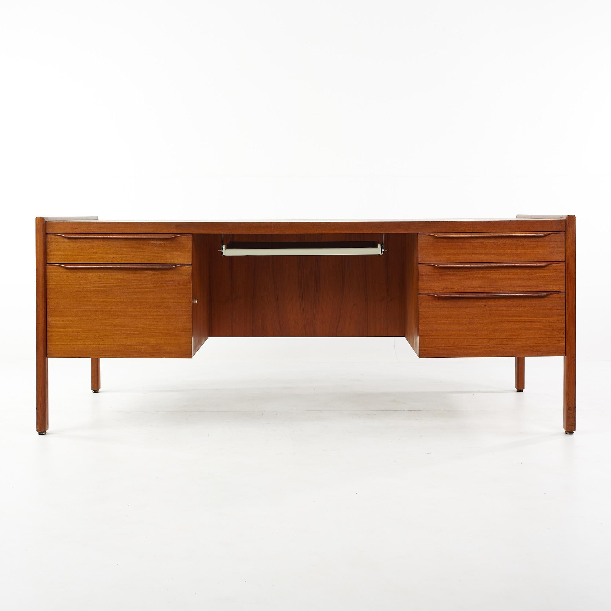 Arne Vodder style mid century teak executive desk

This desk measures: 72 wide x 37 deep x 29.5 high, with a chair clearance of 27 inches

All pieces of furniture can be had in what we call restored vintage condition. That means the piece is