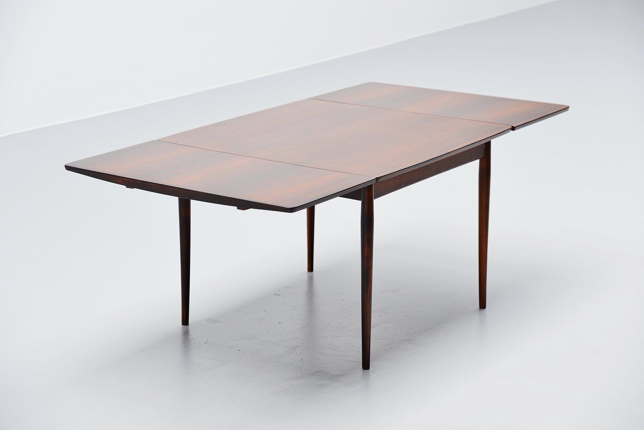 Very nice small rosewood dining table model #220 designed by Arne Vodder and manufactured by Sibast mobler, Denmark, 1960. This is for a very nice subtle sized table in very nice grained rosewood. The table has 2 extension leaves and can turn from a