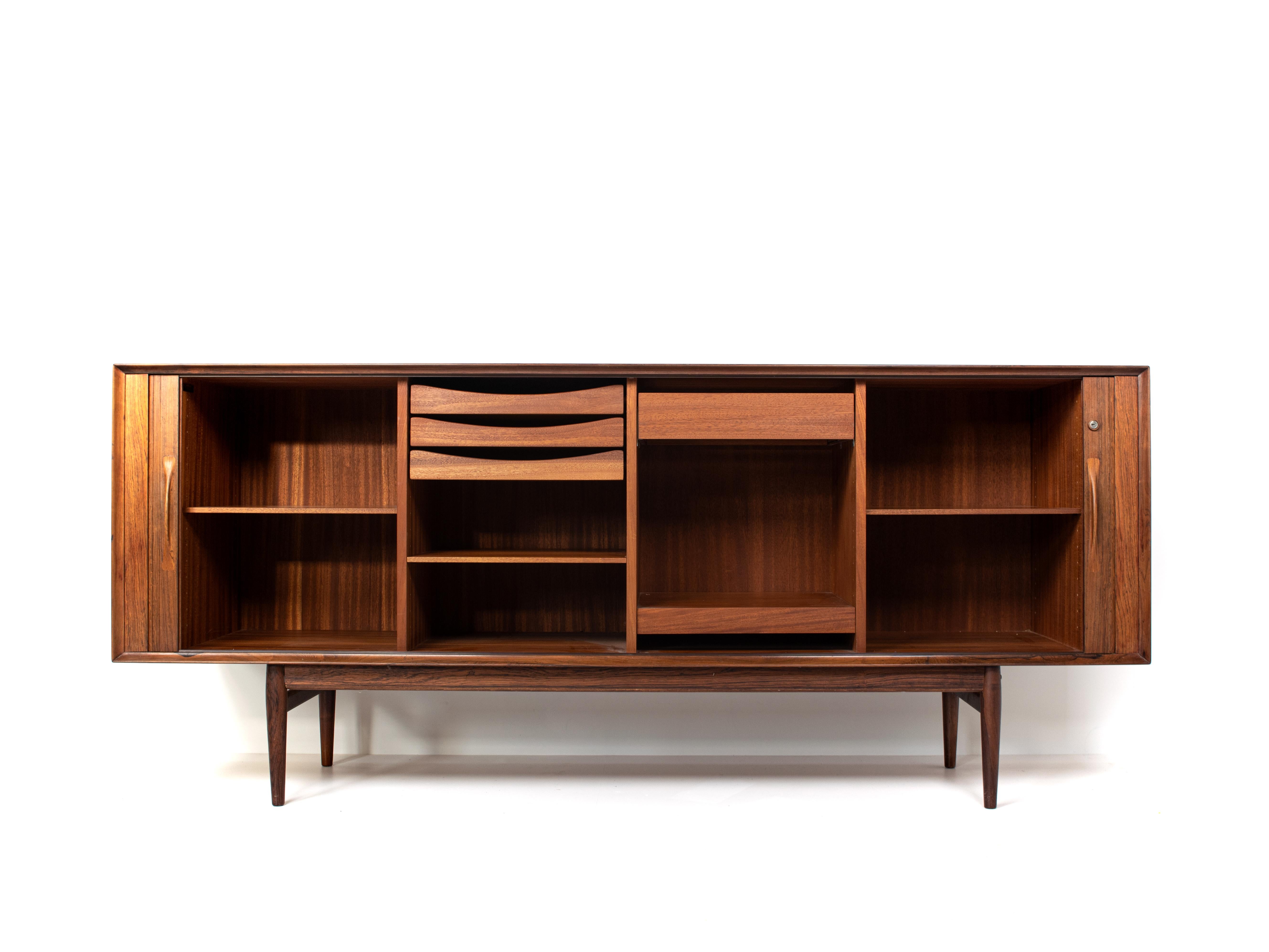 Stunning Arne Vodder sideboard with tambour doors in rosewood for Sibast Møbler from Denmark, 1960s. It's Minimalist design. The craftsmanship on the tambour doors stands out. The doors slide easily with small panels of wood, it is very impressive.