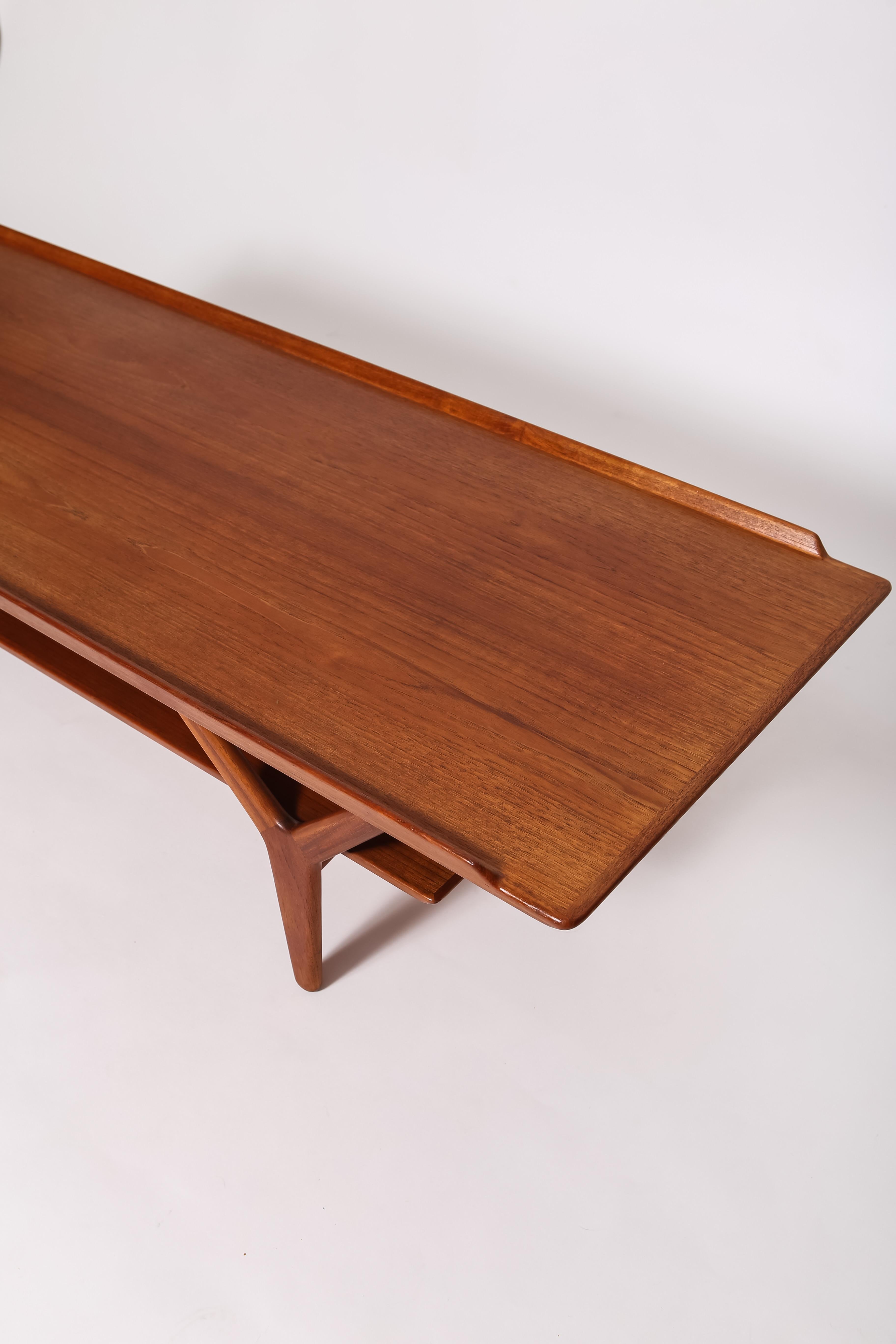 Sculptural teak coffee table by Arne Vodder for Vamø Søndeborg. Features beautiful lines, two tiers, brass hardware and fantastic sculpted legs. Rare one, imported from Denmark, gently restored. 