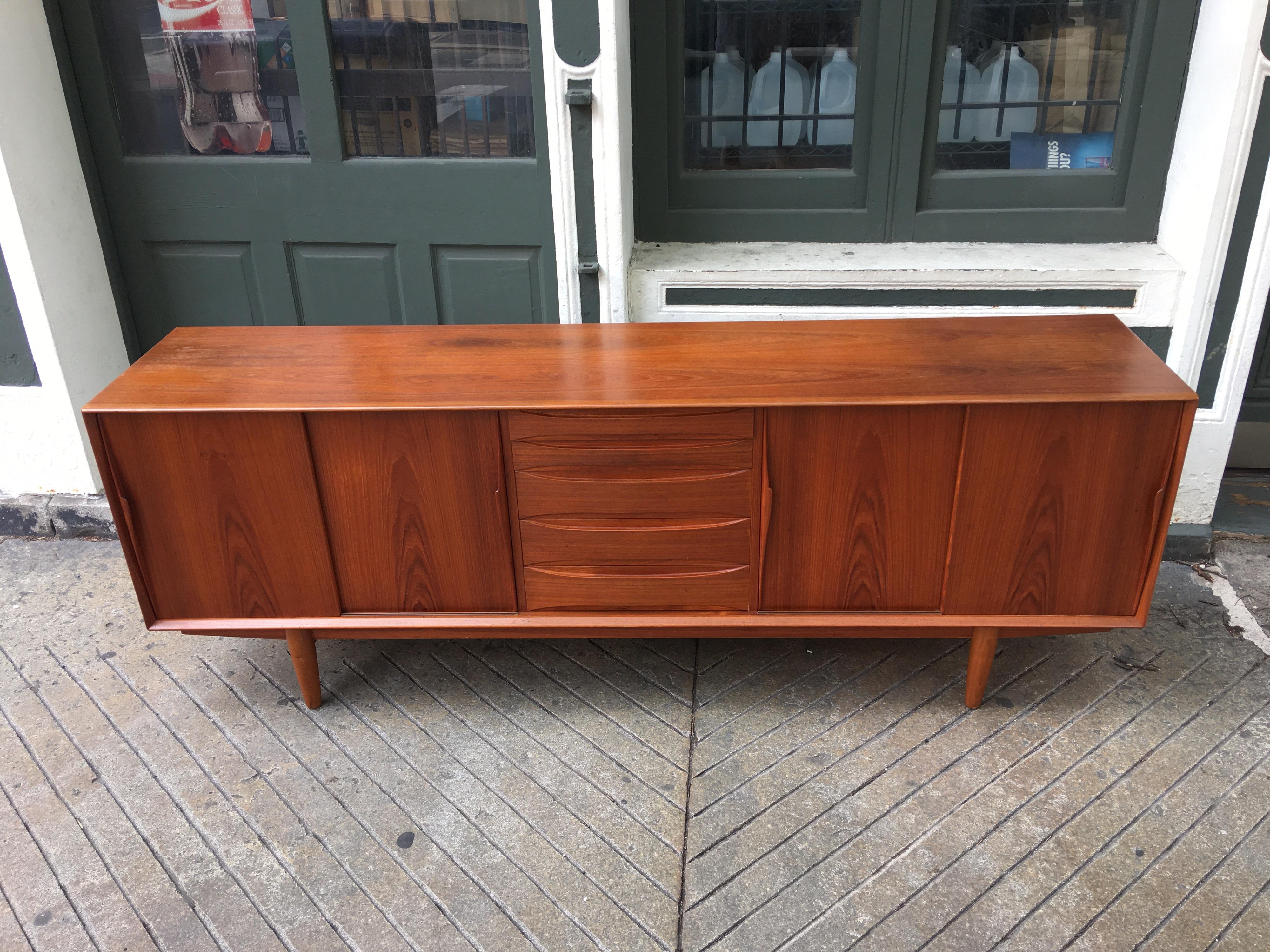 Arne Vodder teak credenza, newly cleaned and re-oiled! Nice large size, measuring 86.5 long, 18.5 deep and 31.5 tall. Beautiful grain with sliding doors on ends to reveal open shelves, and 5 drawers in the center. Top 2 drawers lined in felt. Very