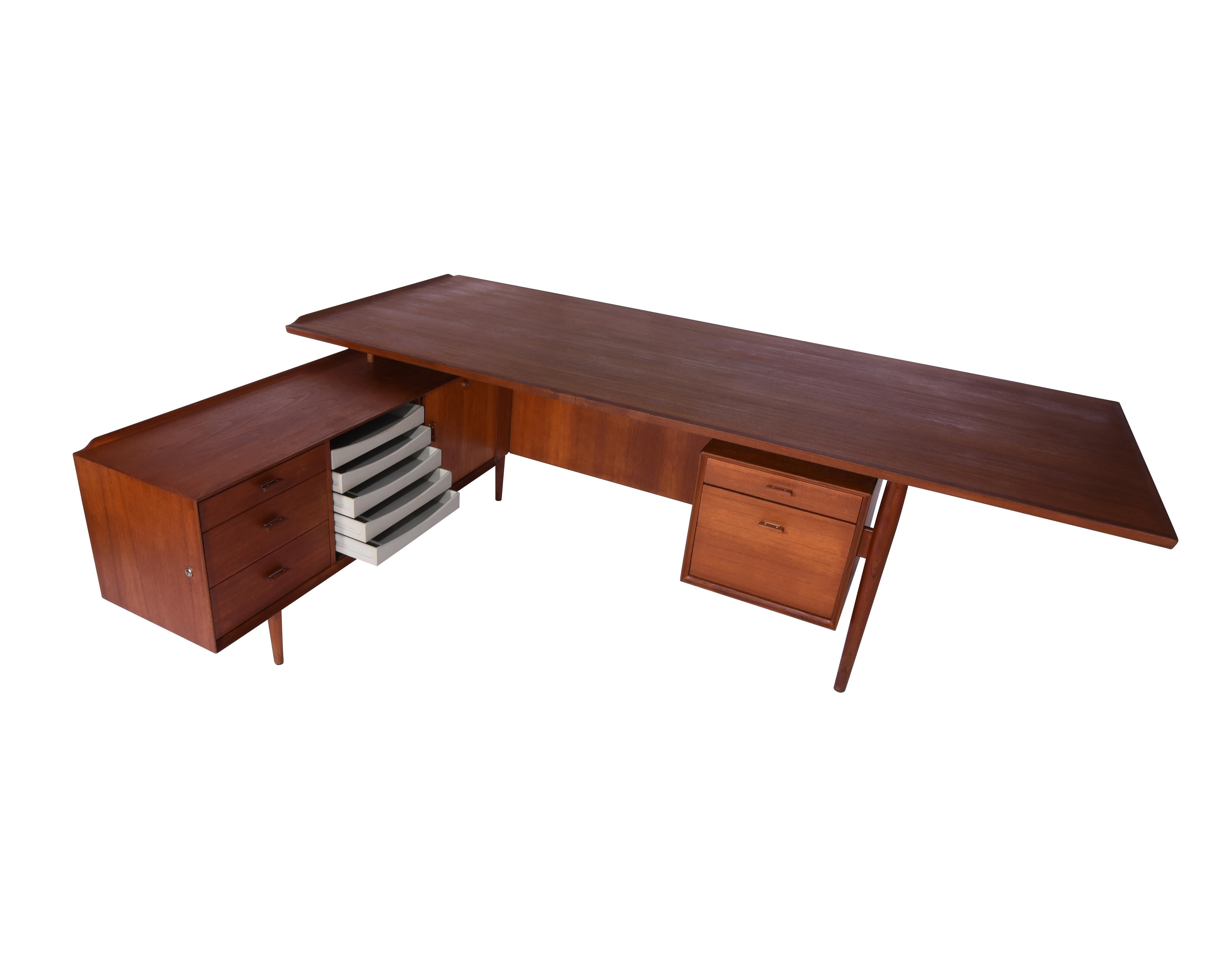 Teak executive desk by Arne Vodder for Sibast. Made in Denmark, circa 1960s. This is the rare 8 foot long desktop model which cantilevers at one end. Meticulously restored and ready to for use.

Desk measures 89 in long x 41 in deep x 29 in