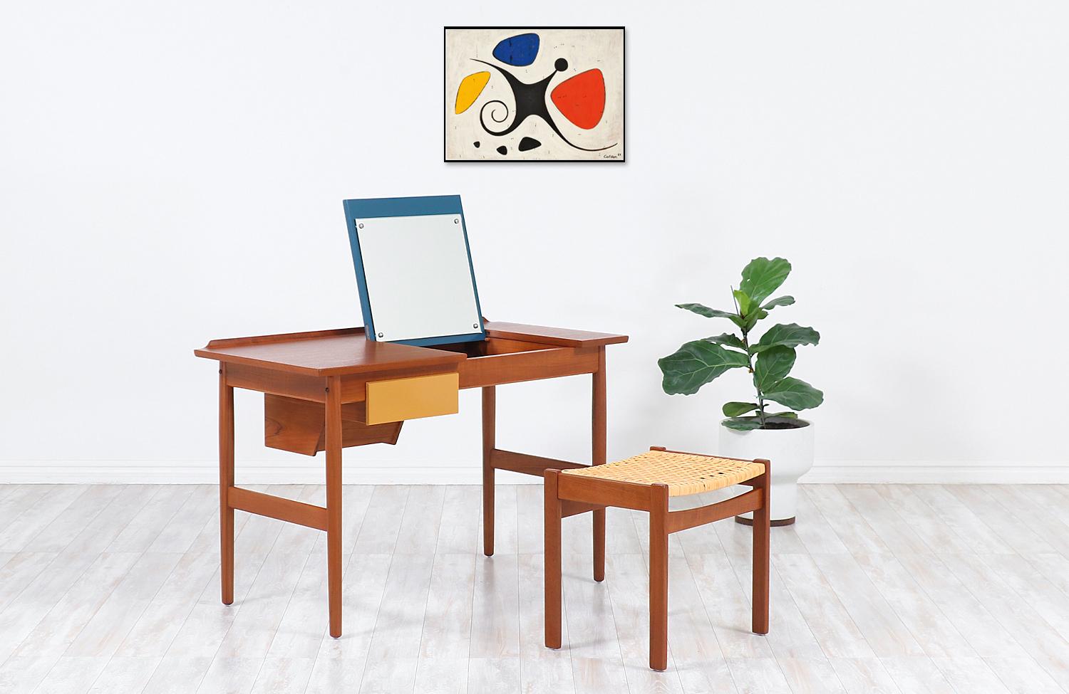 One of our most functional and stylish desk that doubles as a vanity designed by Arne Vodder for the workshop of Sibast Møbler in Denmark during the 1950s. Our elegant Scandinavian writing desk is constructed from a solid teak frame with a stunning