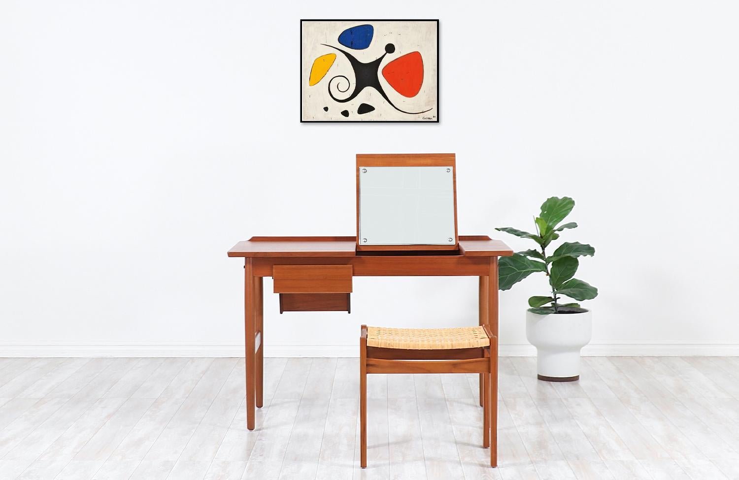 One of our most functional and stylish desk that doubles as a vanity designed by Arne Vodder for the workshop of Sibast Møbler in Denmark during the 1950s. Our elegant Scandinavian writing desk is constructed from a solid teak frame with a stunning