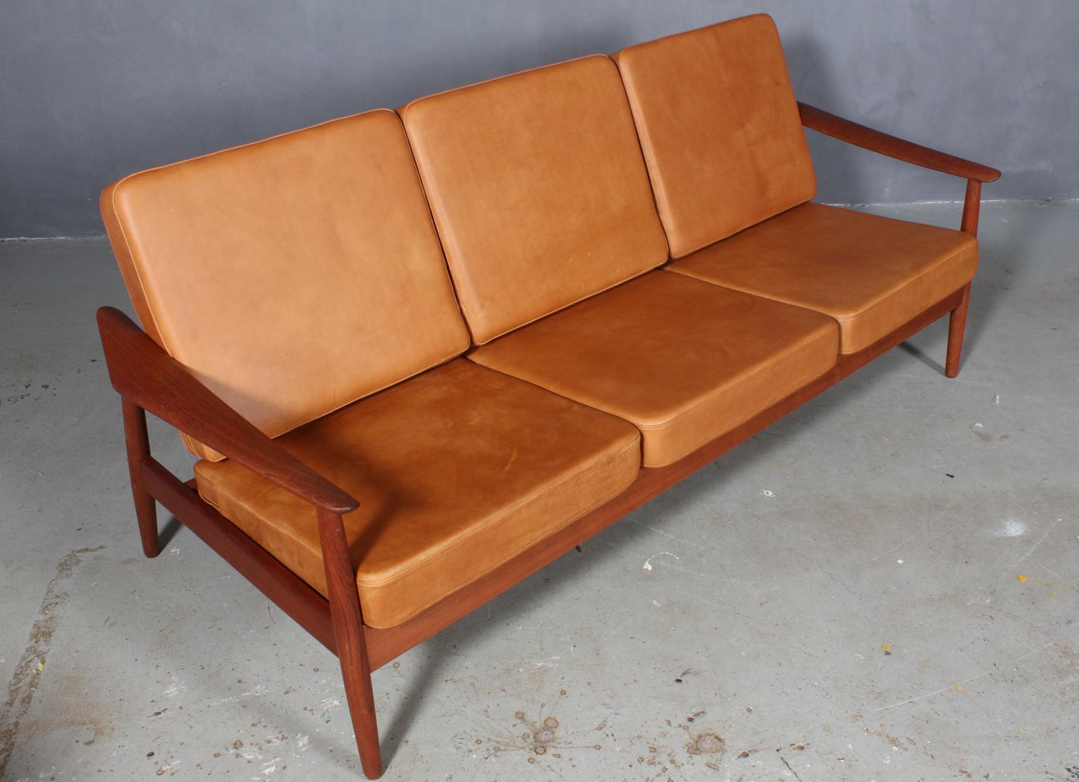 Arne Vodder three-seat sofa with teak frame and organic armrests.

New upholstered with tan aniline Vintage leather.

Model 165/3, made by France & Son.