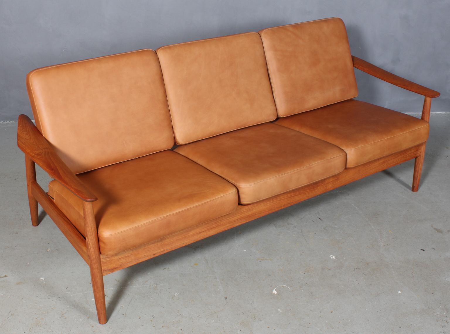 Arne Vodder three-seat sofa with teak frame and organic armrests.

New upholstered with tan aniline Vintage leather.

Model 165/3, made by France & Son.