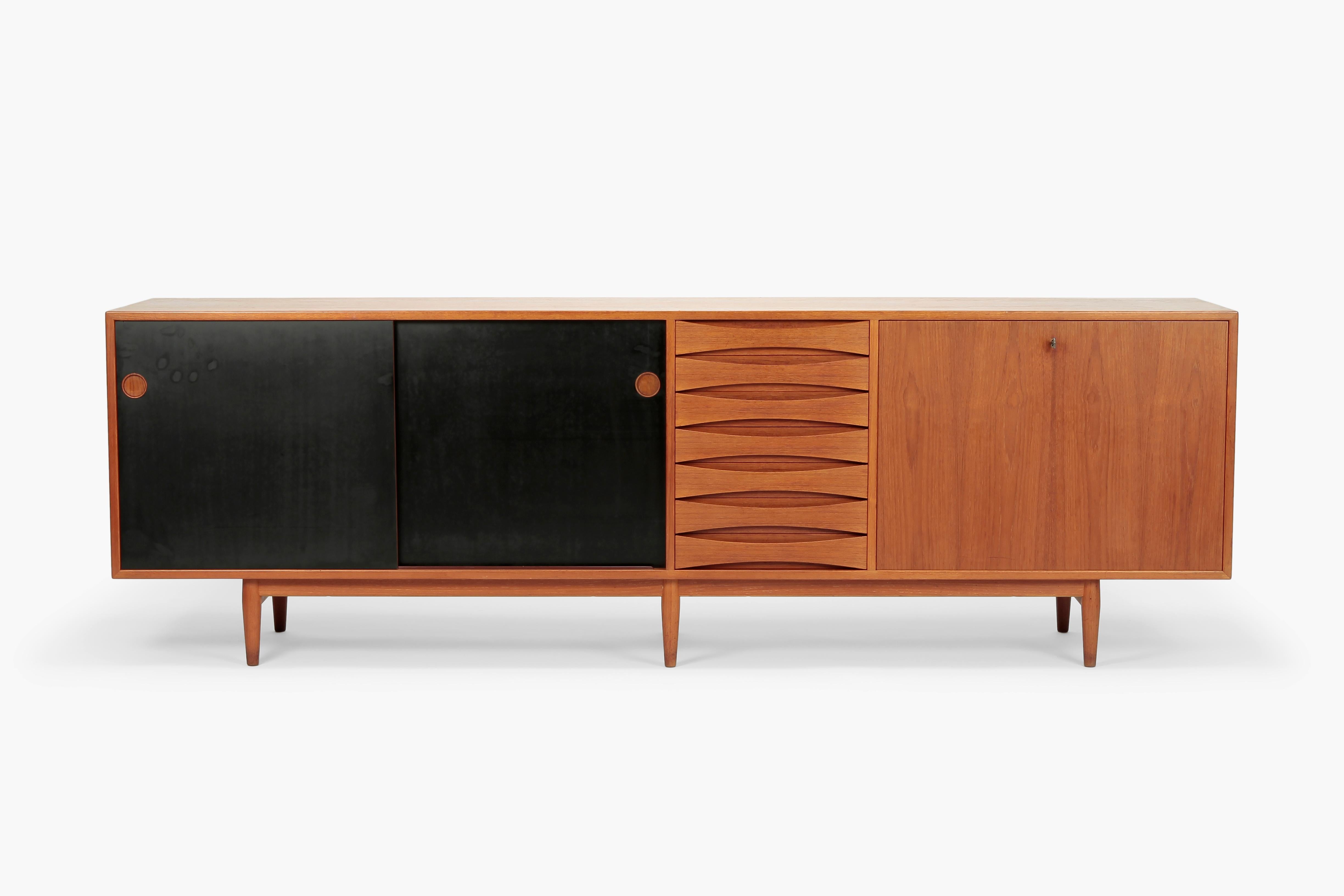 Huge Arne Vodder sideboard Triennale Model 29A was designed in 1959 for the Milan Triennale and manufactured by Sibast in the 1960s. Made of partly solid, partly veneered teak with reversible doors, one side black coated, the other teak surface. The