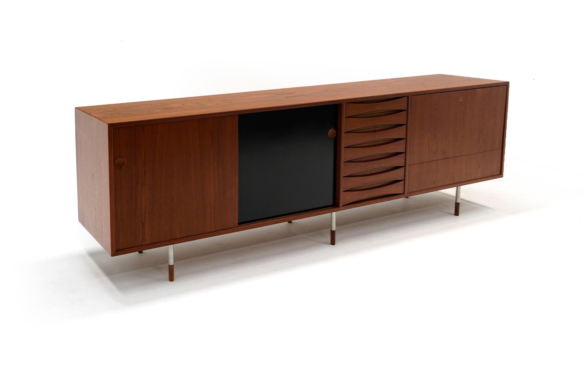 Stunning, iconic, long storage cabinet designed by Arne Vodder for Sibast, model 29A, Denmark, 1959. This is a very rare version with the teak and chrome legs and reversible teak and black doors. Expertly restored and refinished this is a good as