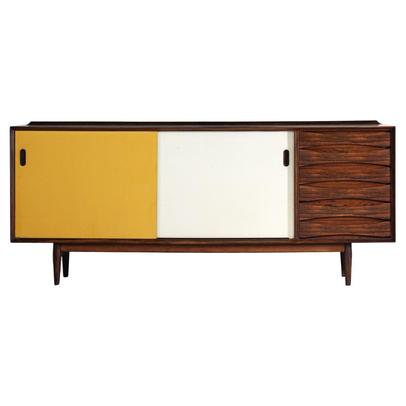 Beautiful scandinavian sideboard model 29 designed by the famous danish designer Arne Vodder for Sibast in the 60's. Solid and veneered rosewood structure. The front is composed of six half-moon drawers, two reversible sliding doors (painted in
