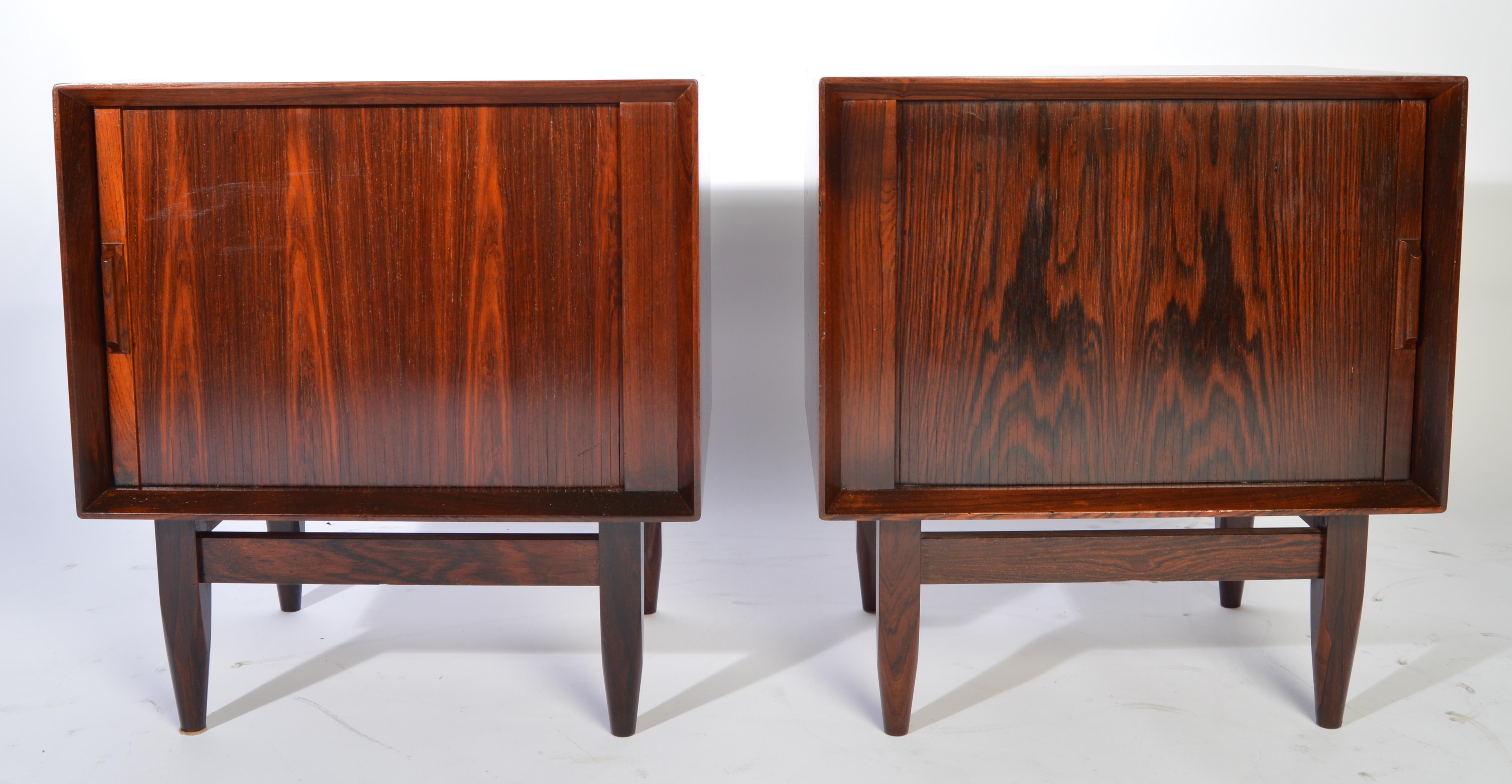 Arne Wahl Iversen Brazilian rosewood nightstands having tambour doors that reveal a top drawer and shelved lower case storage.
Outstanding overall condition. Masterfully refinished,
circa 1960.