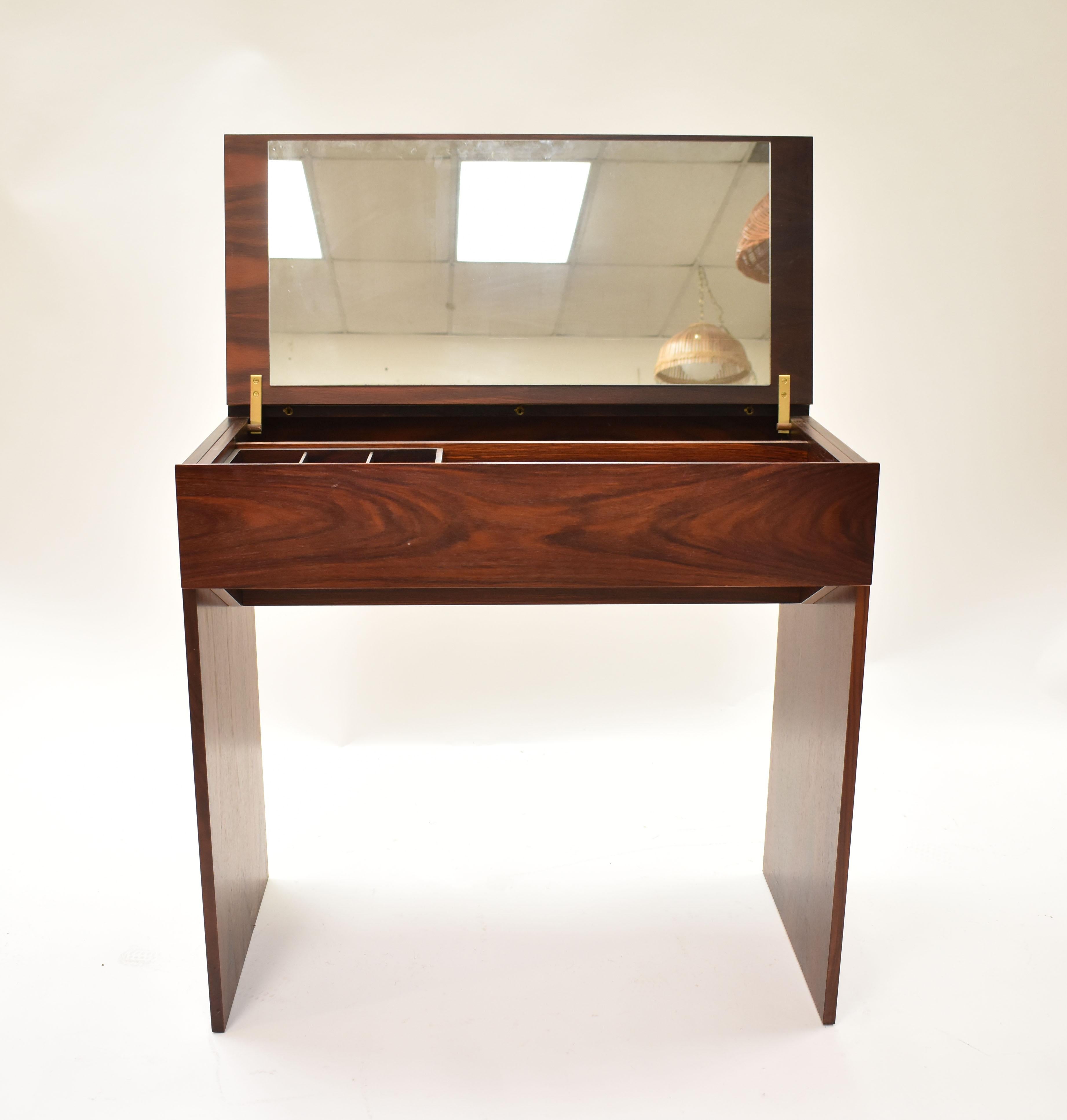 Lovely Danish rosewood vanity dressing table designed by Arne Wahl Iversen for Vinde Mobelfabrik. Flip top with mirror, storage drawer and brass fittings. Stamped Vinde Mobelfabrik on the back. 
 