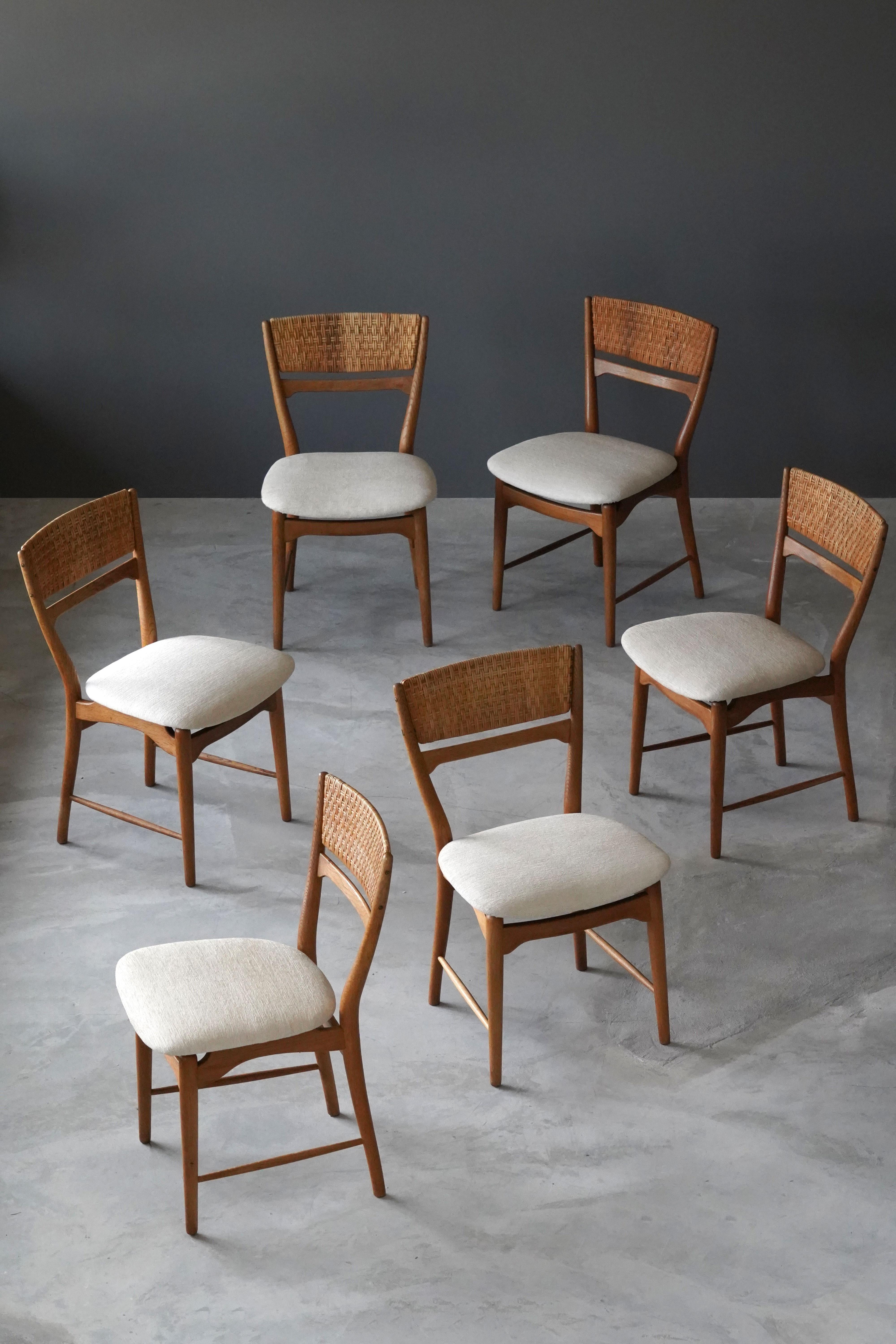 A dining group consisting of six dining chairs model 271 T, designed by Danish designer Arne Wahl Iversen in 1957. Produced by Sorø Stolefabrik, Denmark. Sculpted oak is paired with woven cane backs and overstuffed fabric seats.

Other designers