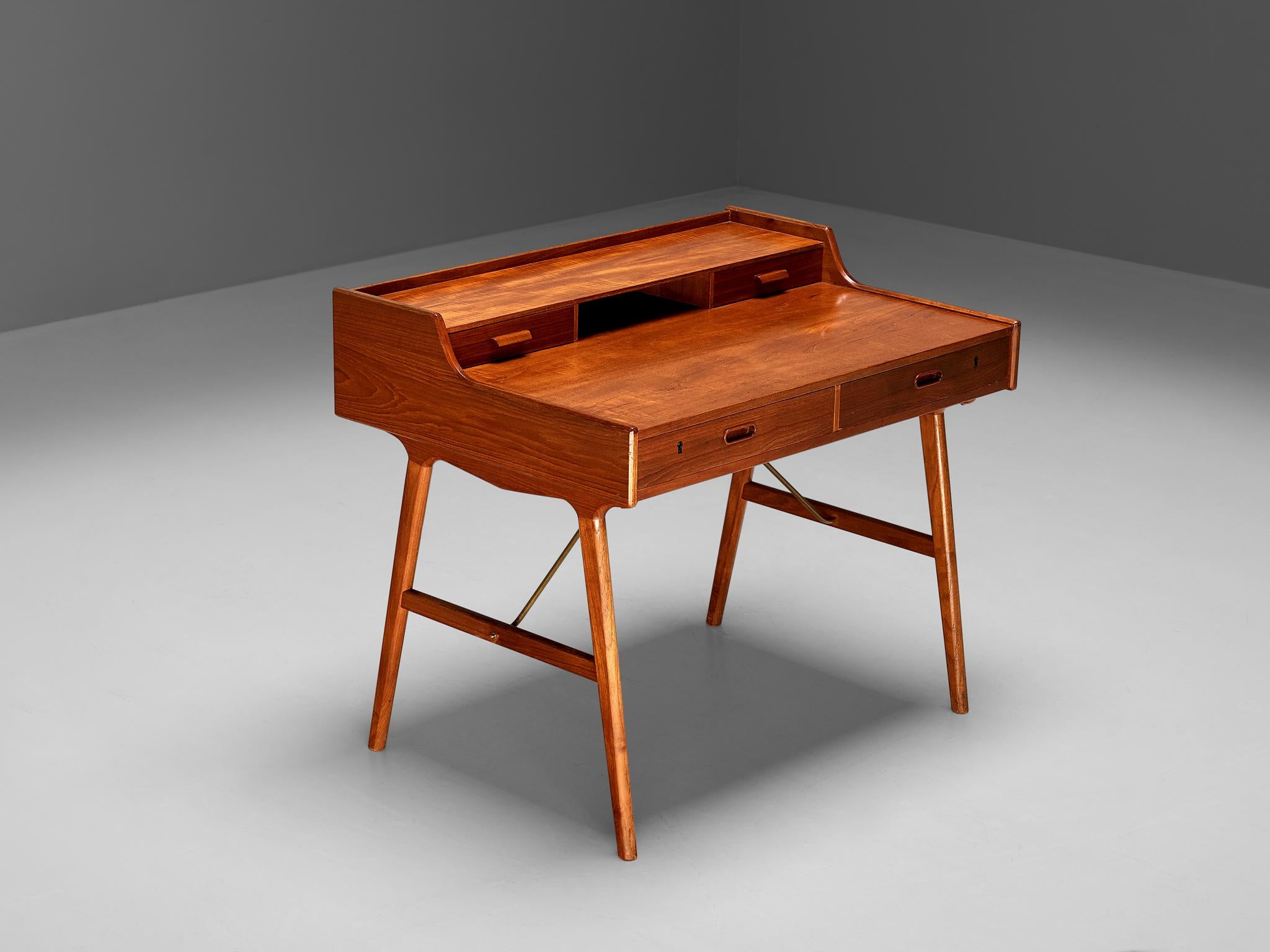 Arne Wahl Iversen for Vinde Møbelfabrik, desk, model 65, teak, brass, Denmark, 1960s.

Refined desk by Danish designer Arne Wahl Iversen. This small writing table has a beautiful open look due to the high cylindrical legs. The table with two levels
