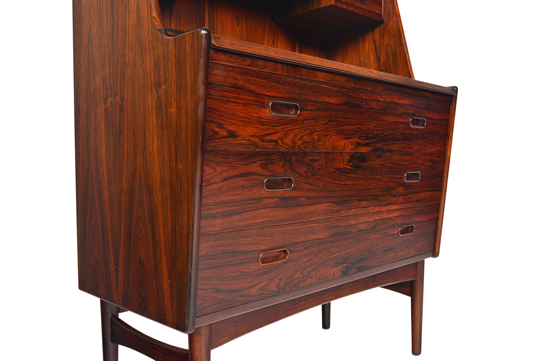 This lovely Danish modern secretary desk Model 60 in rosewood was designed by Arne Wahl Iversen for Vinde Møbelfabrik in the 1960s. This piece offers spacious storage and an easy to access workspace. Beautifully crafted drawers and storage dividers