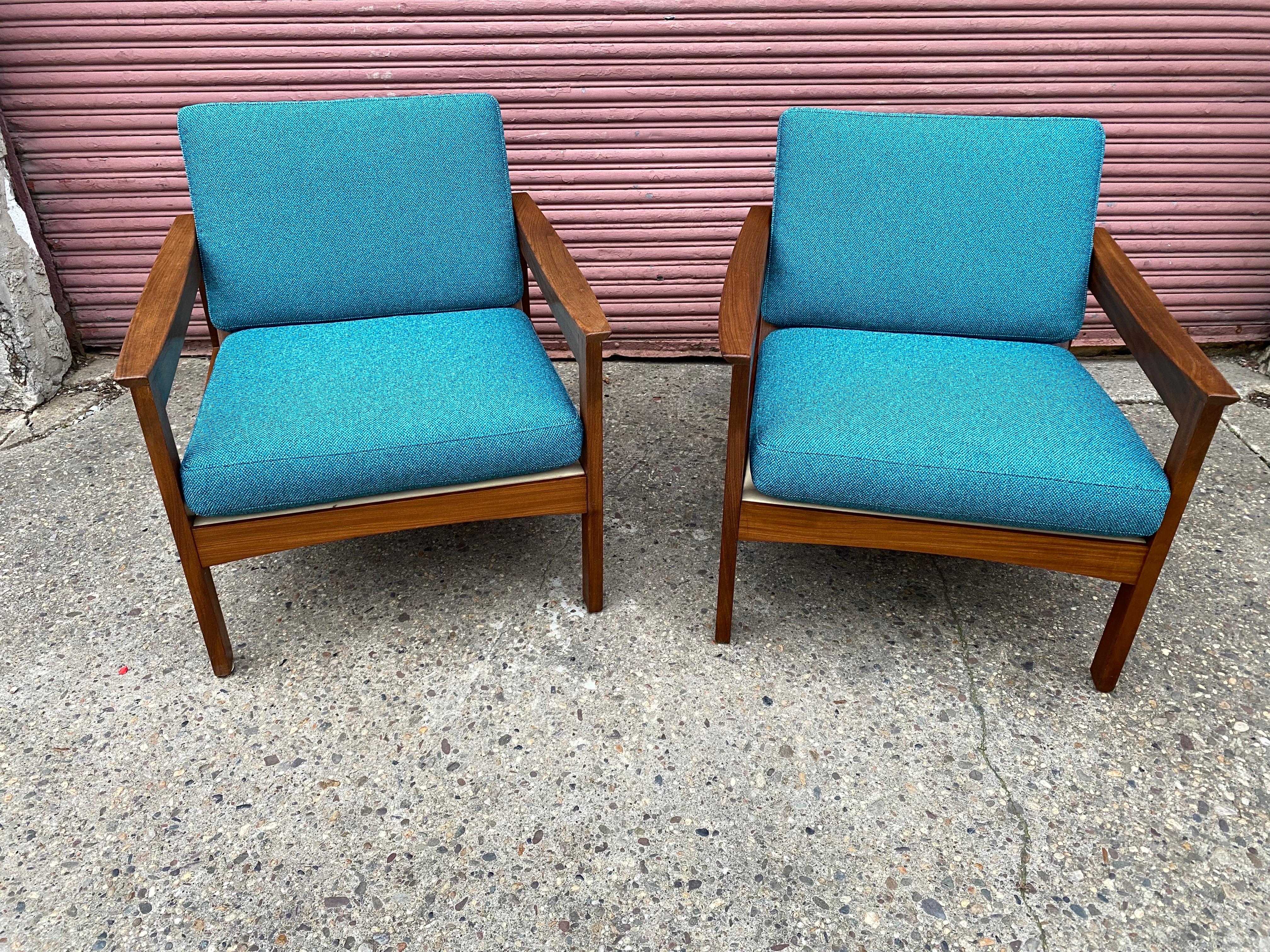 Pair of Solid Teak Open Arm Lounge Chairs attributed to Arne Wahl Iversen for Komfort, Made in Denmark.  New Upholstered Cushions in a fabric with multiple shades of blues.  Nice vertical back slats look great.  All solid wood construction and ready