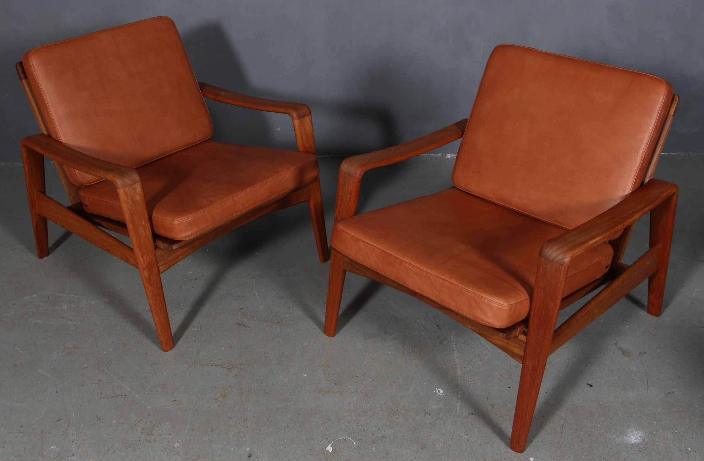 Arne Wahl Iversen. Set of lounge chairs with frame of teak, Loose cushions new upholstered with walnut aniline leather, 1960s. Manufactured by Komfort.

