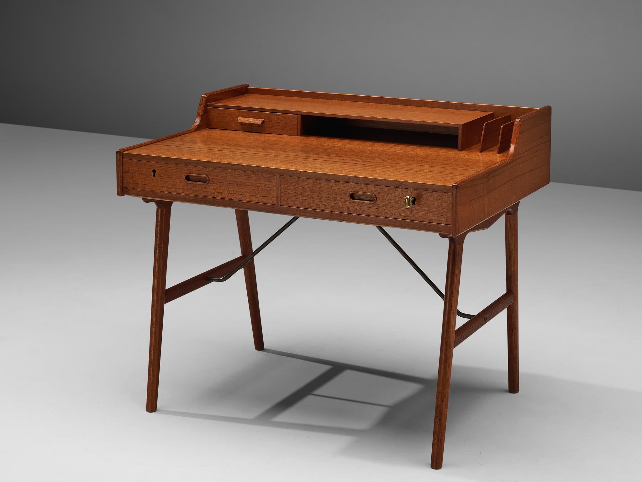 Arne Wahl Iversen for Vinde Møbelfabrik, desk model 65, teak, Denmark, circa 1961.

Refined desk table by Danish designer Arne Wahl Iversen. This small writing table has a beautiful open look due the high cylindrical legs. The table with two