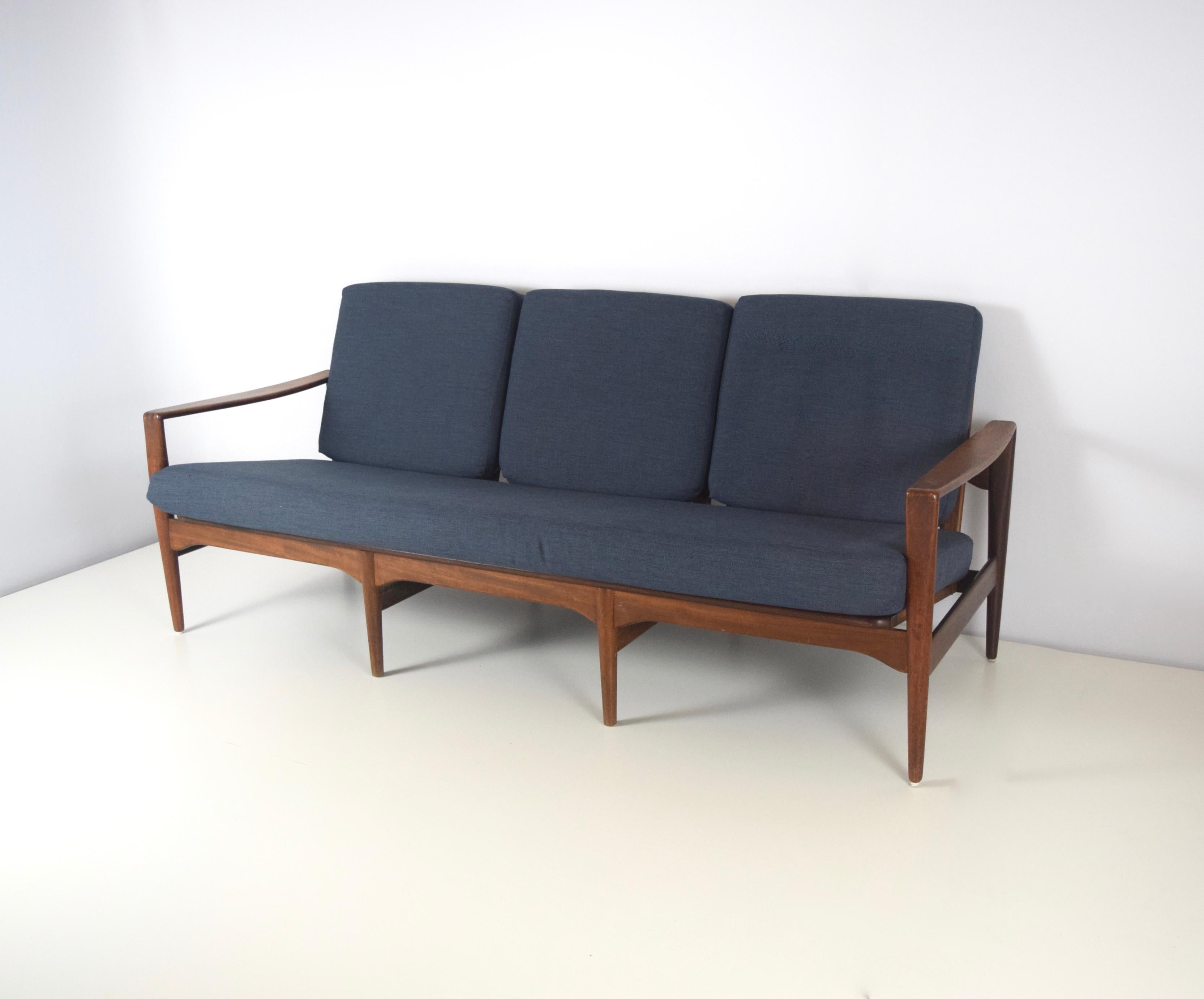 Modern Arne Wahl Iversen sofa for Komfort in rosewood from Denmark, 1950s. This is a 3-seat sofa with excellent upholstery in a dark blue, grayish color. The round shapes give it an elegant design. The sofa is in good condition and fits any modern