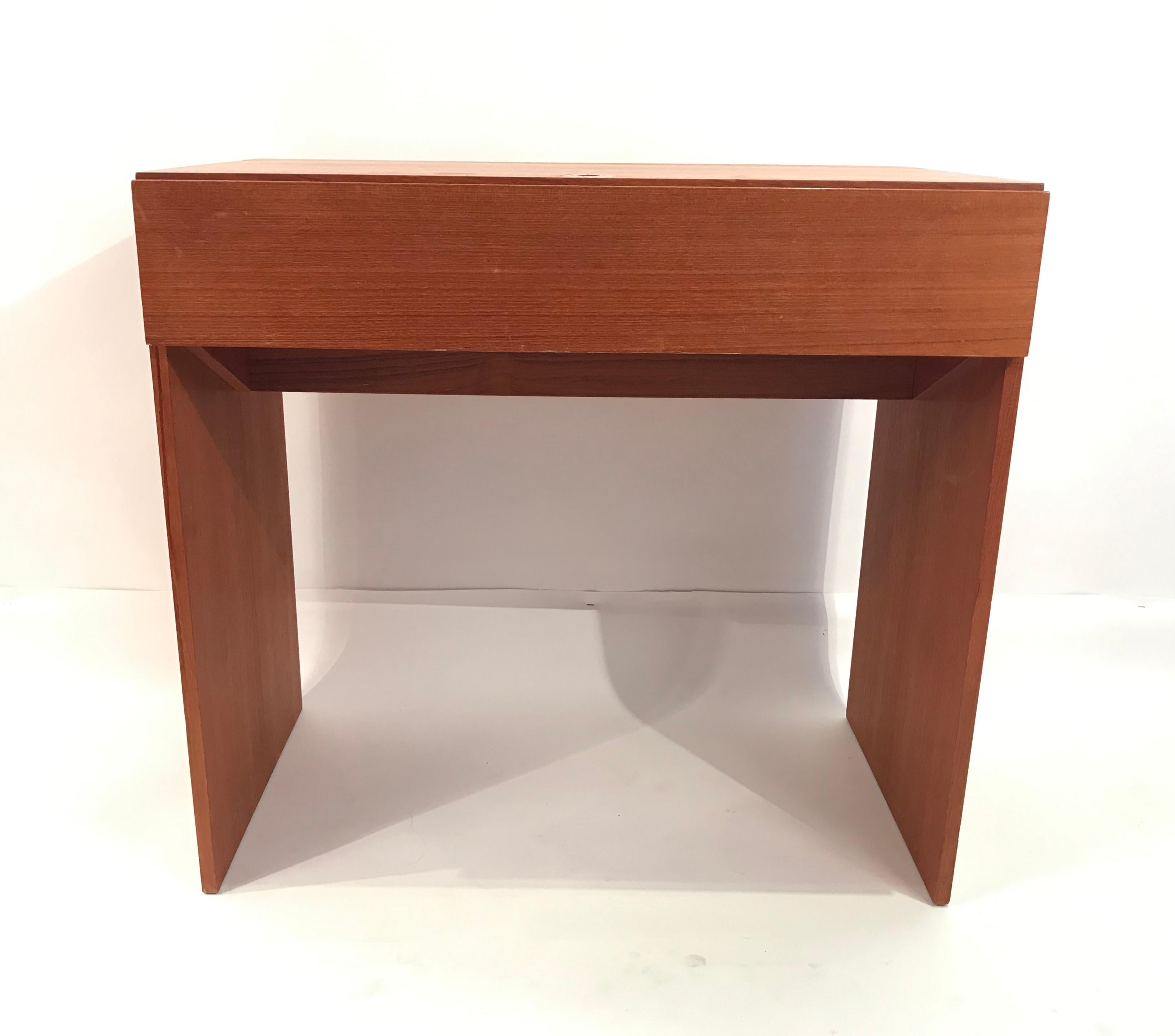 Stylish and compact teak desk with fold up vanity mirror. Interior has space for office storage or cosmetics. Designed by Arne Wahl Iversen and produced in Denmark by Vinde.